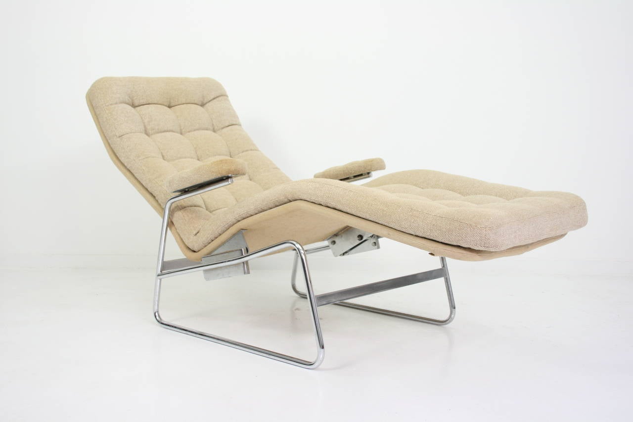 Bruno Mathsson rare adjustable chaise lounge or Dux Sweden having a tufted back, arms and seat, raised on tubular supports, joined by a stretcher.