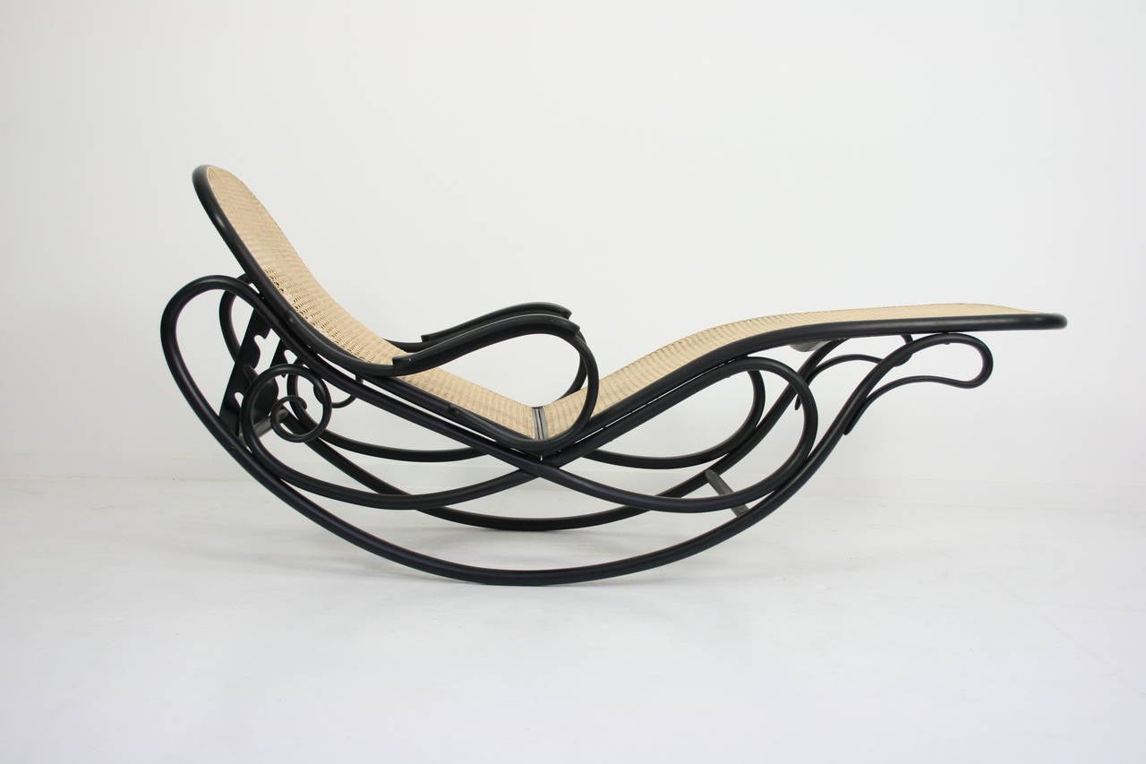 Stained bent beech, cane.
Measures: 100.3 x 64.4 x 176.8 cm (39 1/2 x 25 3/8 x 69 5/8 inches).
Manufactured by Gebruder Thonet, Vienna, Austria. Underside impressed with Thonet.
