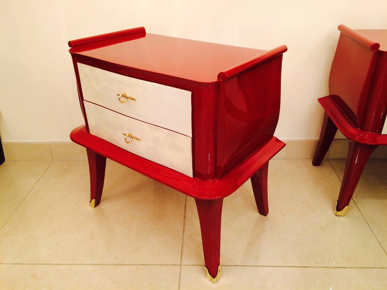 Beautifull pair of 1930's night stands in red lacquered wood, with 2 drawers in parchment .