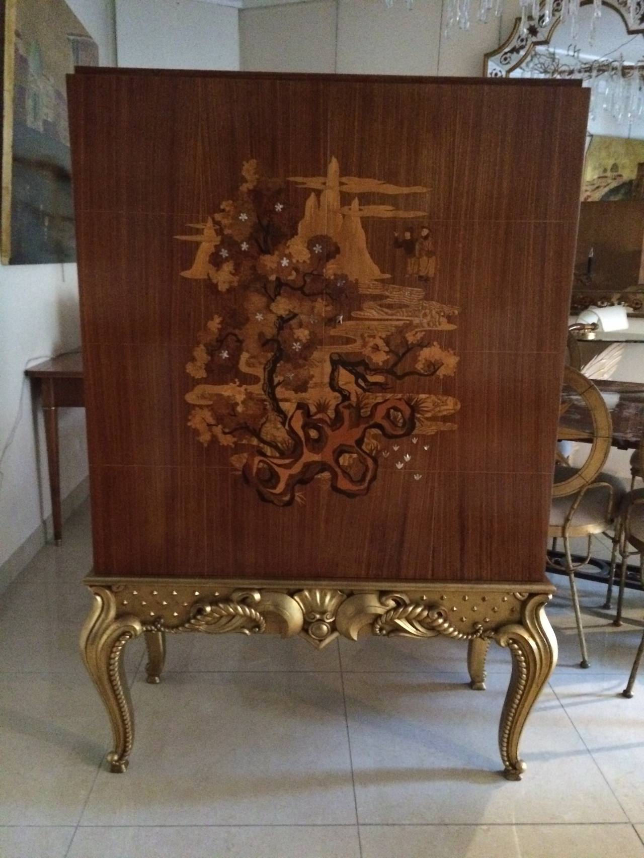 Very rare cabinet on a gold Leaf sculpted legs.
Marqueterie of different woods and mothership of pearls inlays.
Stamped on the inside left door.
MD.