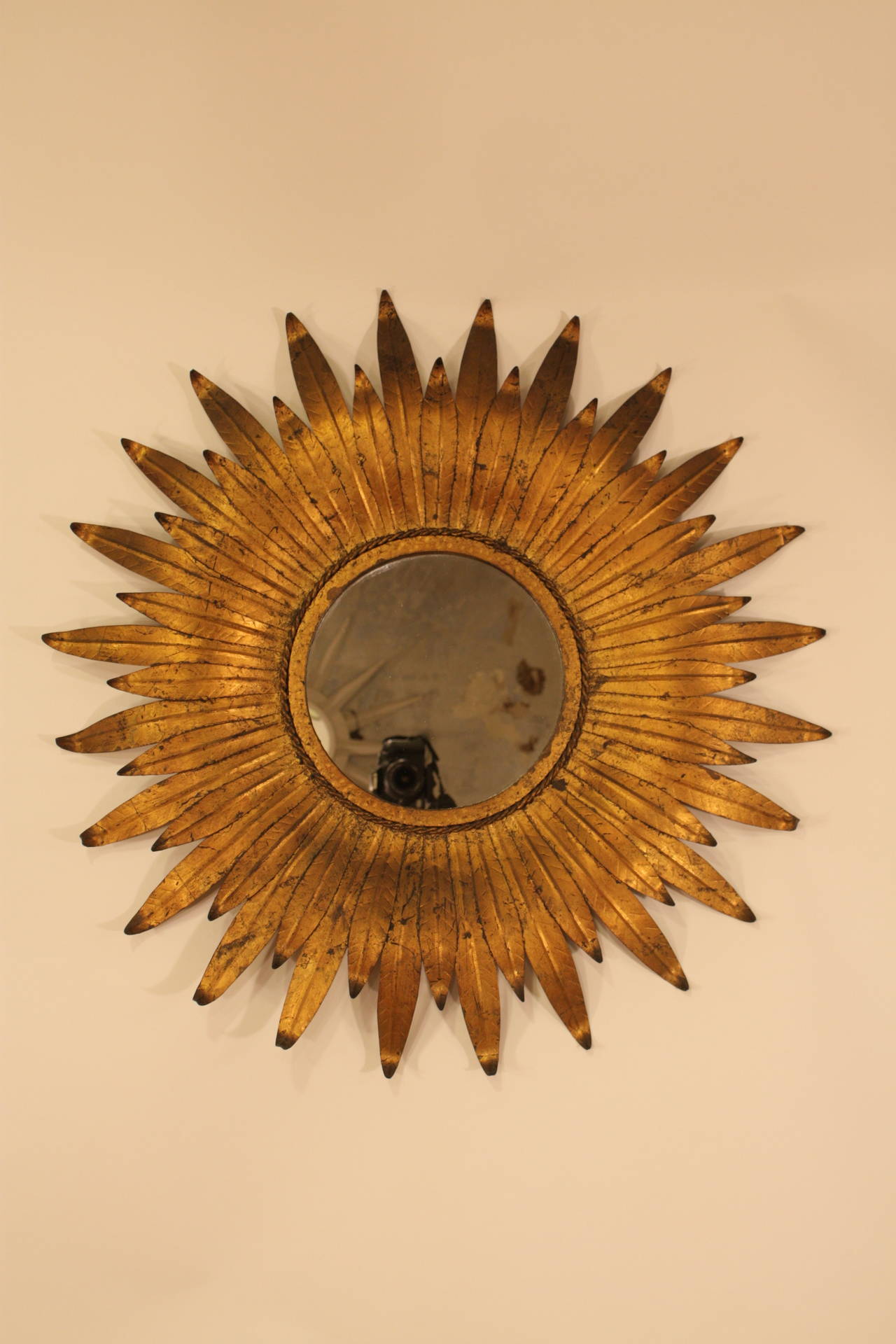 Spanish Gilt Iron Sunburst mirror, curved leaves in two sizes give a gorgeus sensation of movement