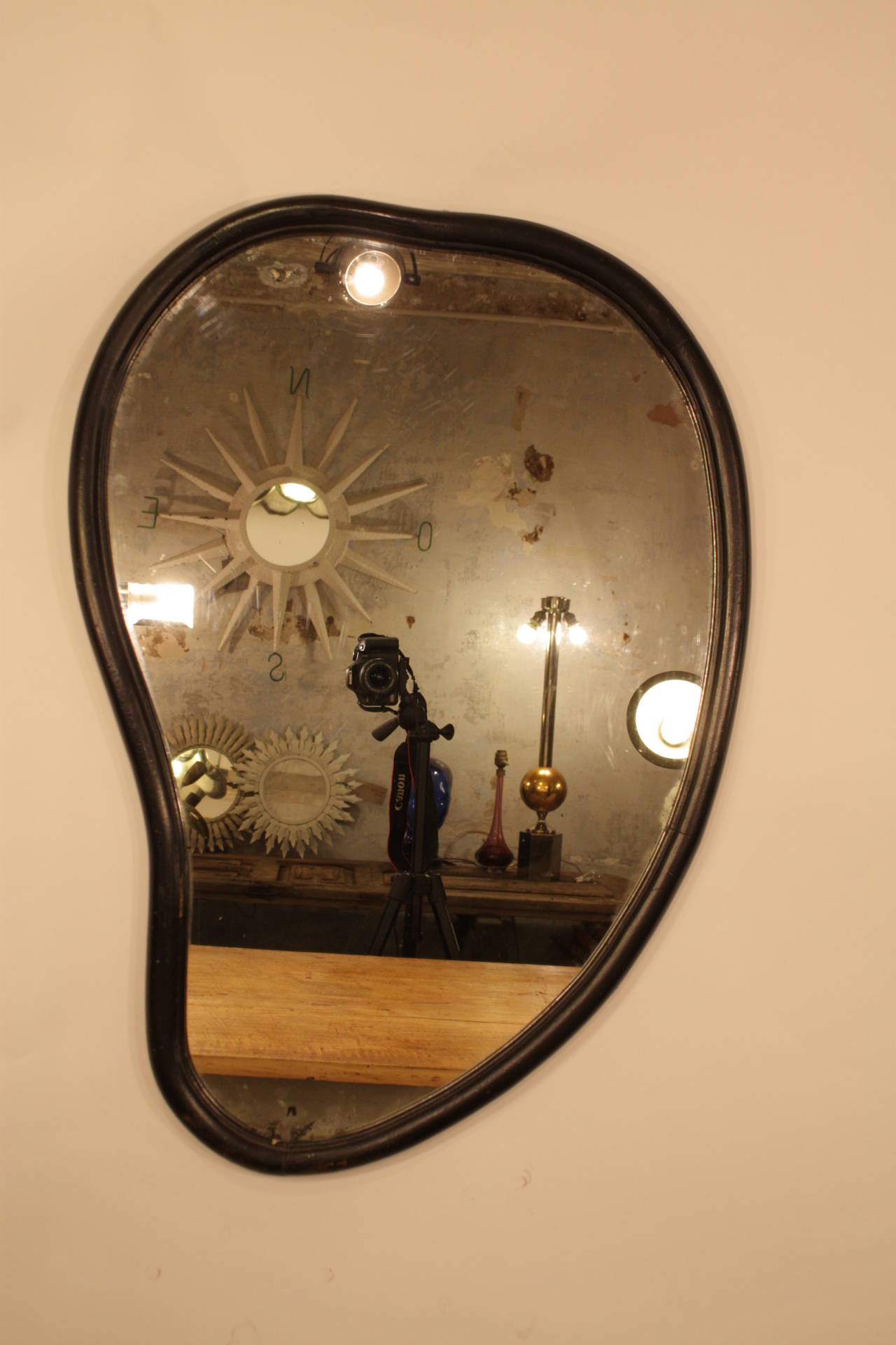 Vintage curved surrealist mirror in the style of Salvador Dali, ebonized carved wood and original mirror.
Spain, 1960s.