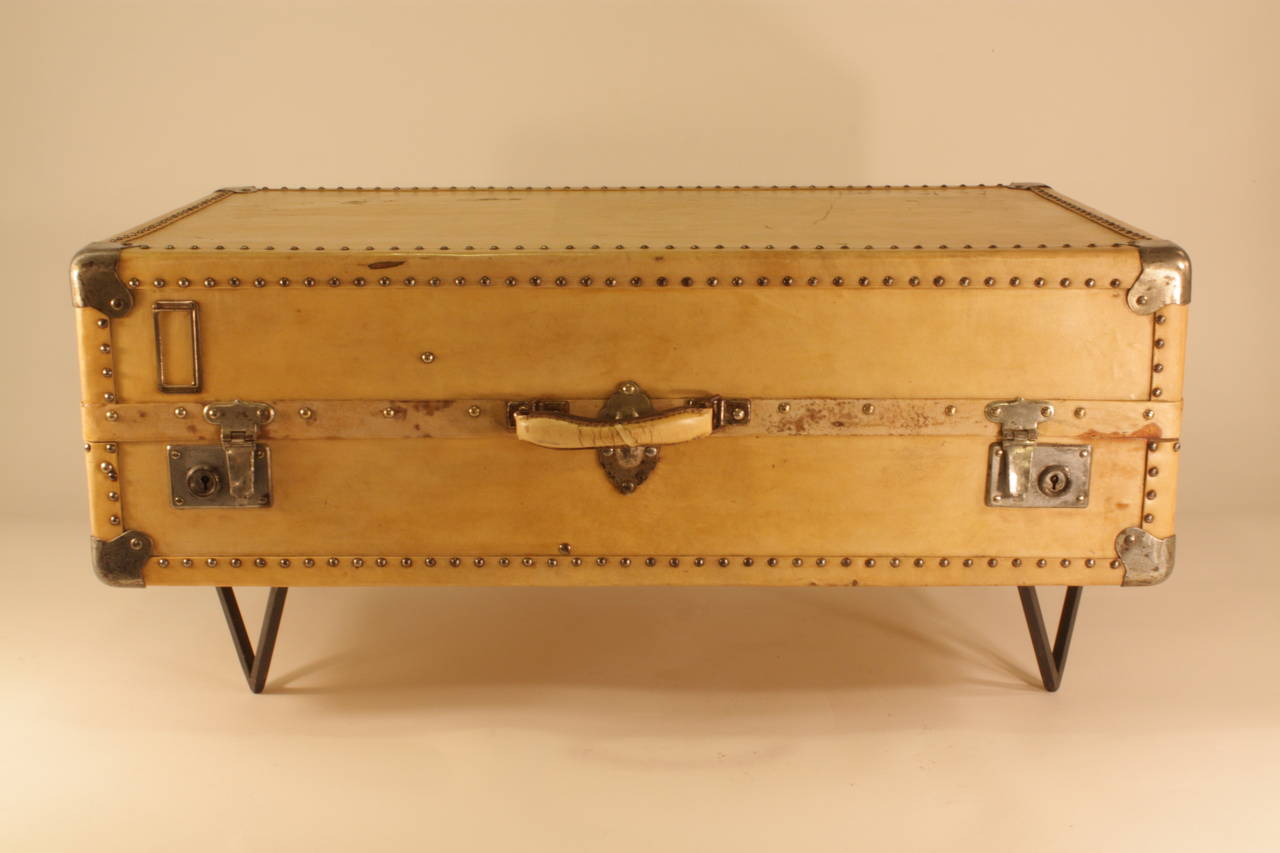 Parchment suitcase from the early 20th century placed as a coffee table on a new iron base. Chromed locks.