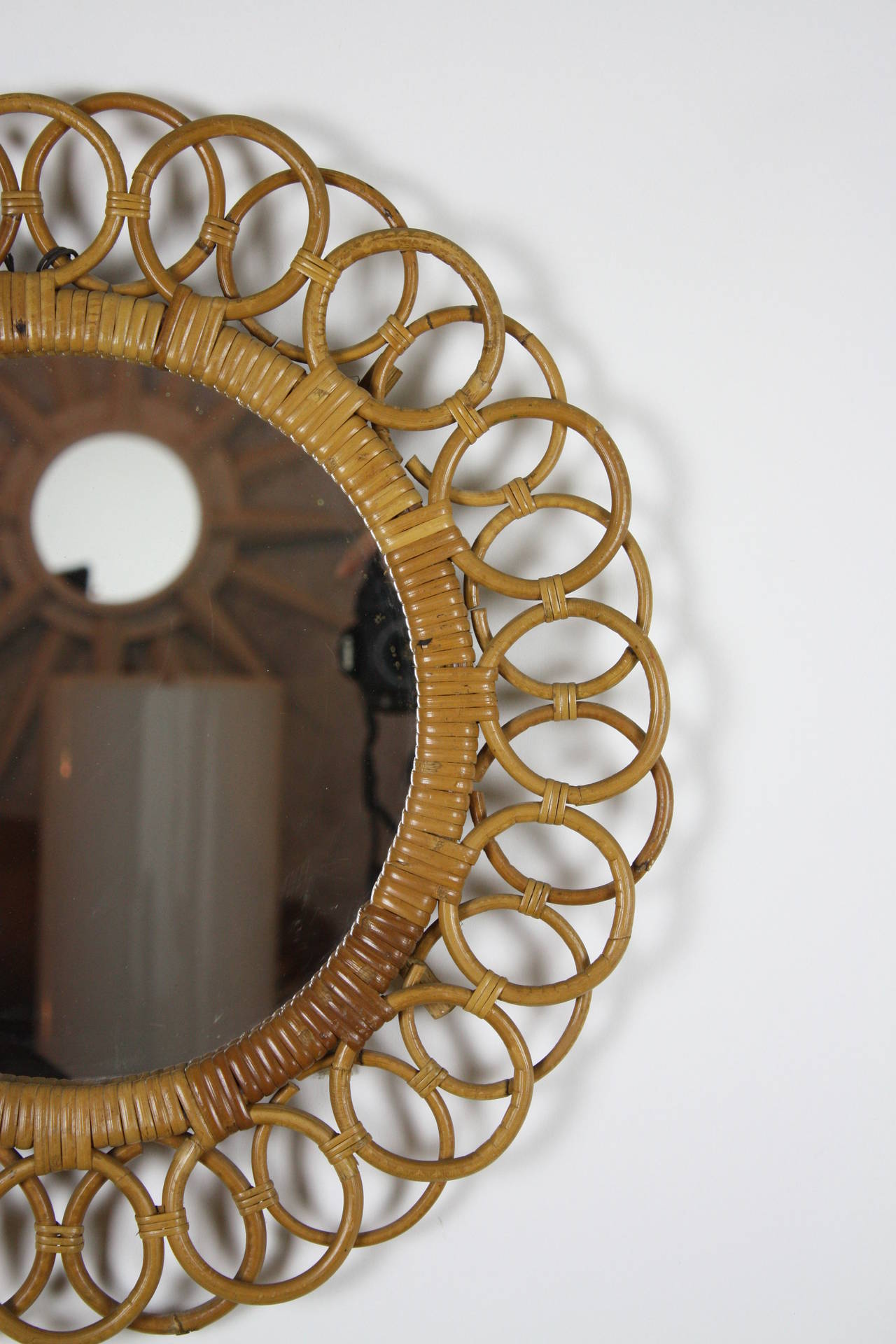 Beautiful framed mirror with small bamboo circles joined between them. Original patina.