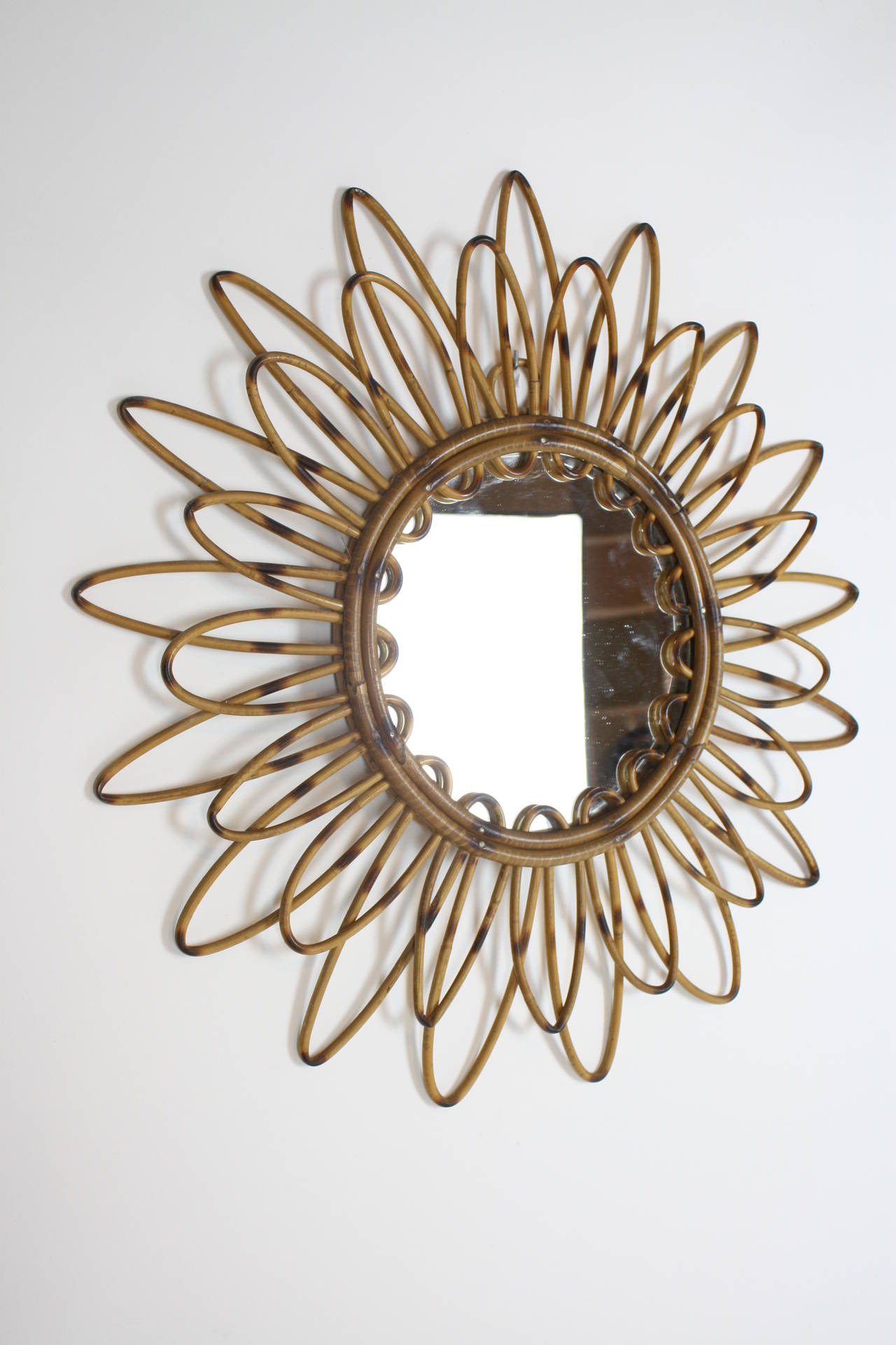 Rattan flower burst or starburst mirror. Beautiful patina with pyro details. Handmade in Spain in the 1960s. Mediterranean Coast style.