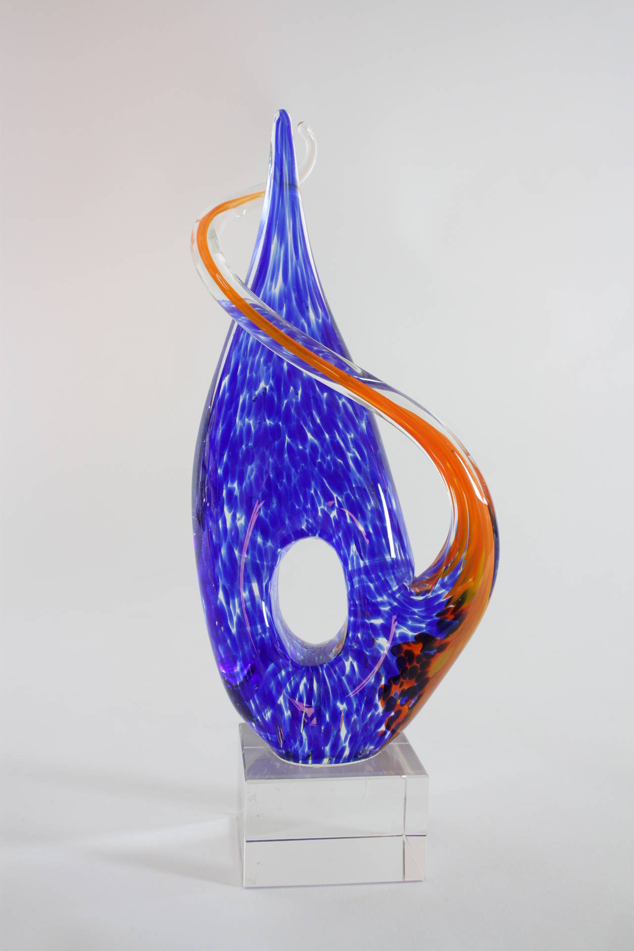 Beautiful abstract Murano glass sculpture. It could be a representation of water and fire with its vibrant orange and blue colors. Artist unknown.
