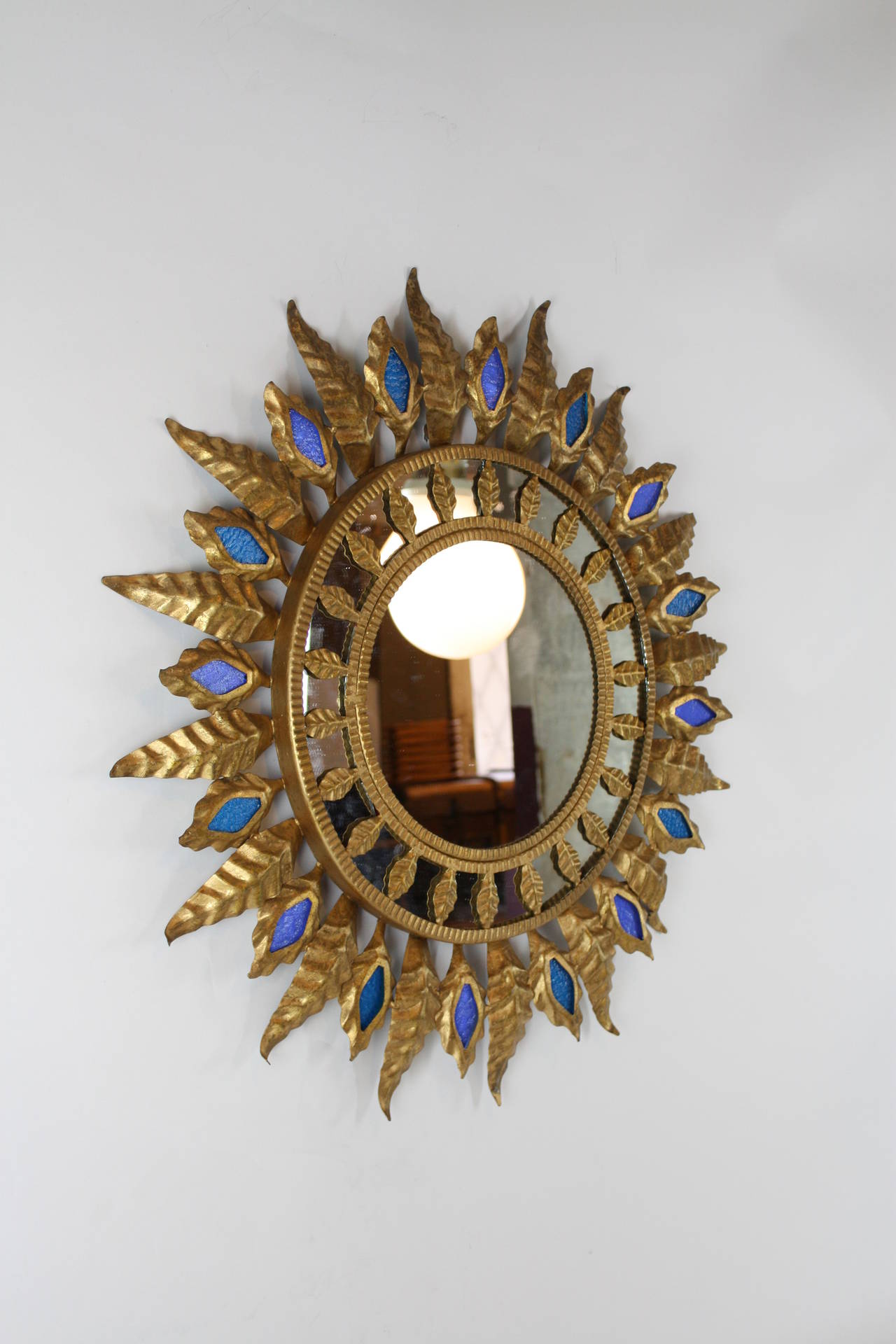 Mid-20th Century Gilt iron sunburst mirror with blue glasses