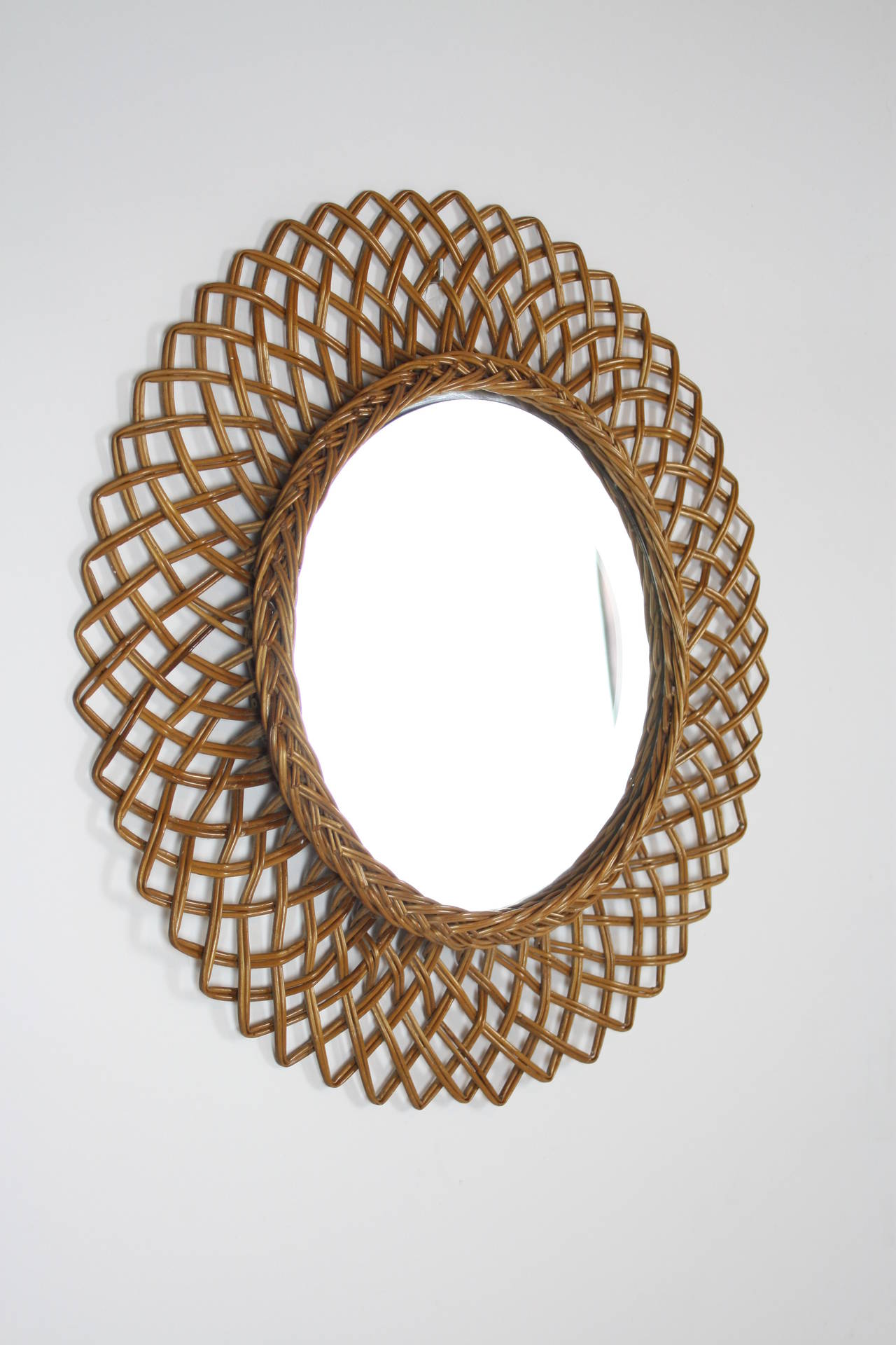 Rattan mirror with beautiful geometric handcrafted design.