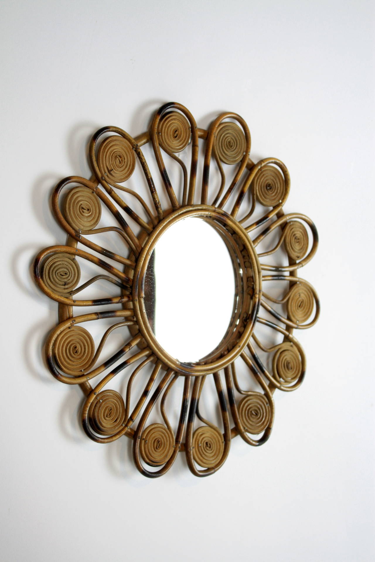 Rare mini flower burst mirror in wicker, Mediterranean coast French style.