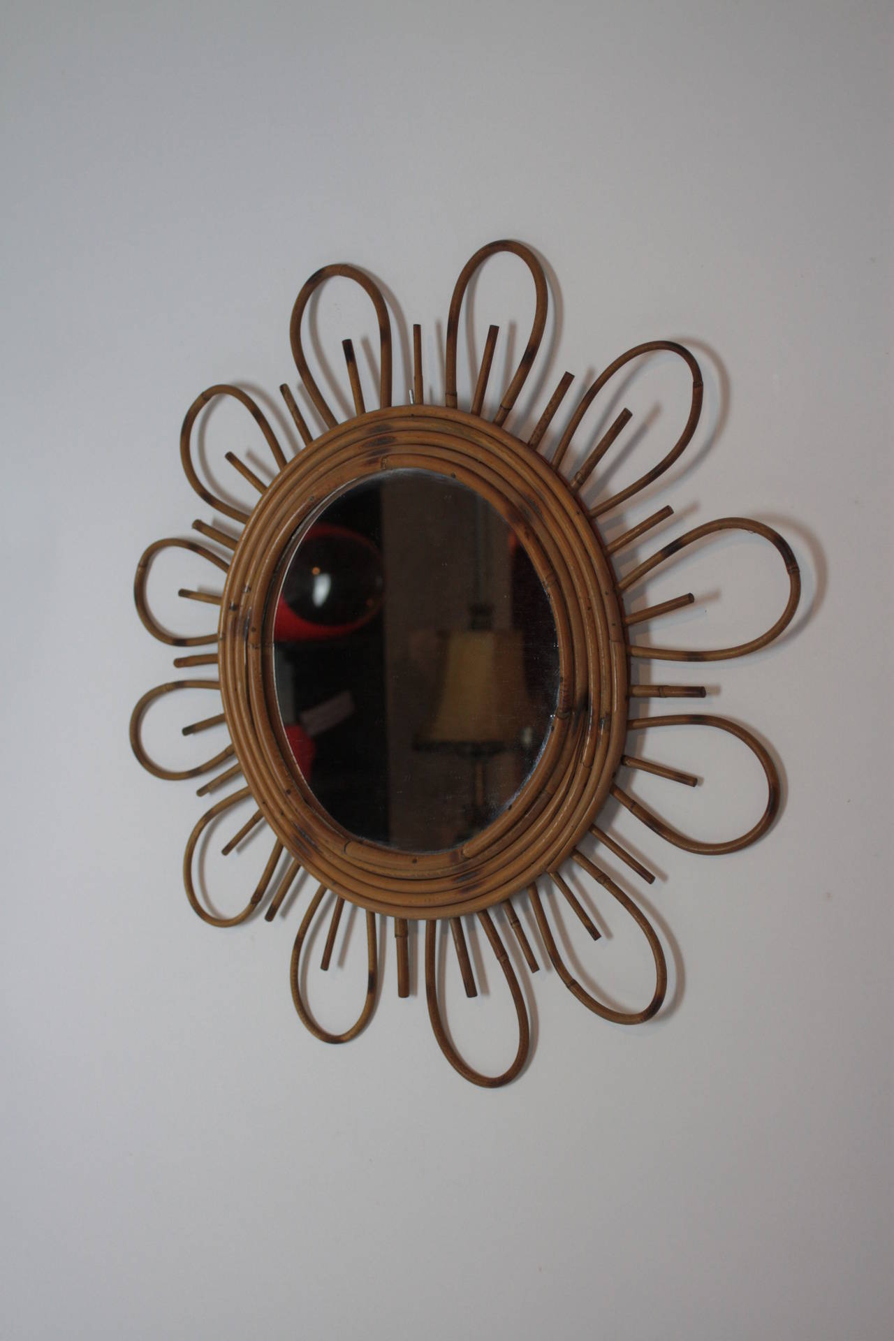 Rattan flower burst mirror. Handmade in Spain at the 1960s. 

Mediterranean Coast style with beautiful design and pyro details.