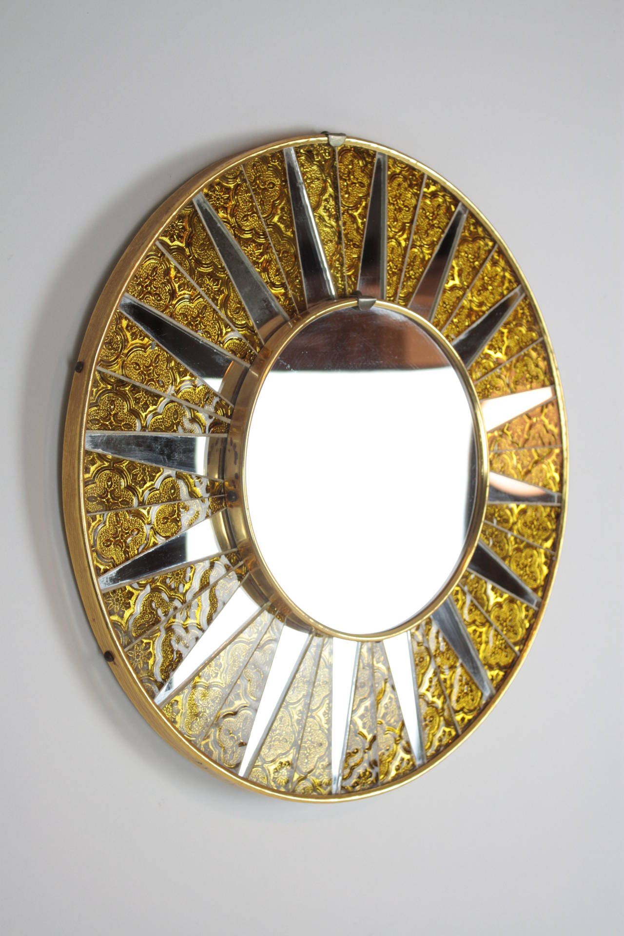 Amazing circular mirror framed with pieces of glass and mirrors creating a sun image.
Spain, 1960s.