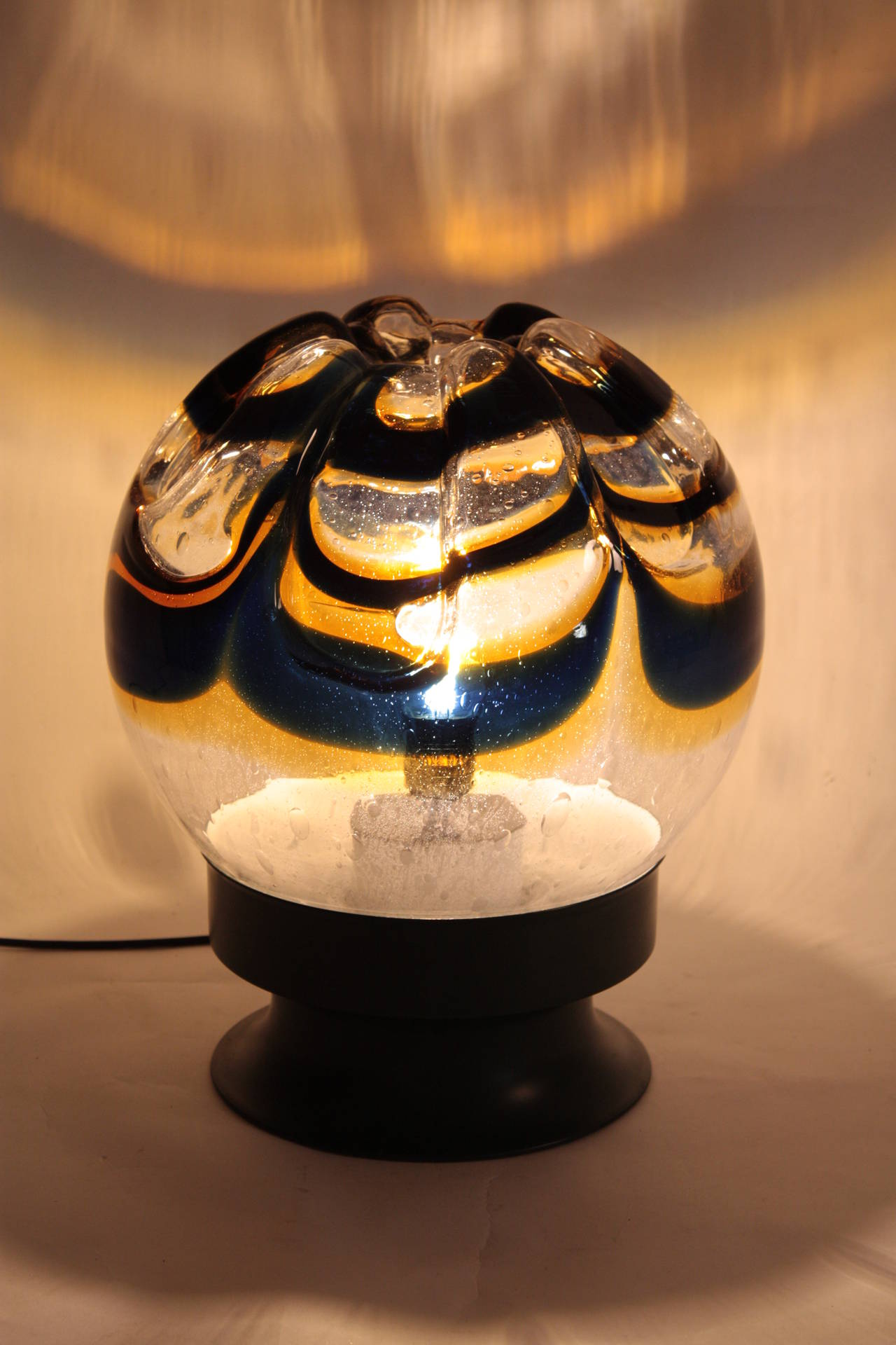 Giant Mazzega Murano glass globe table lamp.

 Green lacquered metal base.