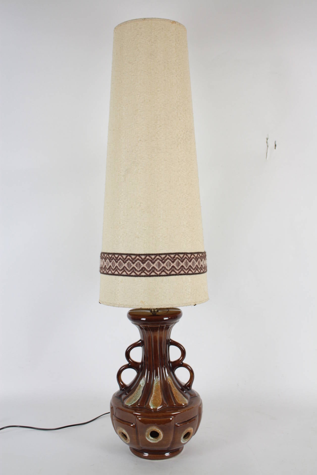 Gorgeous West germany pottery table lamp with its original shade.

It could be used as a floor lamp because it is oversized.

Very beautiful original vintage fabric lamp shade with sewn brown details.

2 bulbs, one at the shade and the other