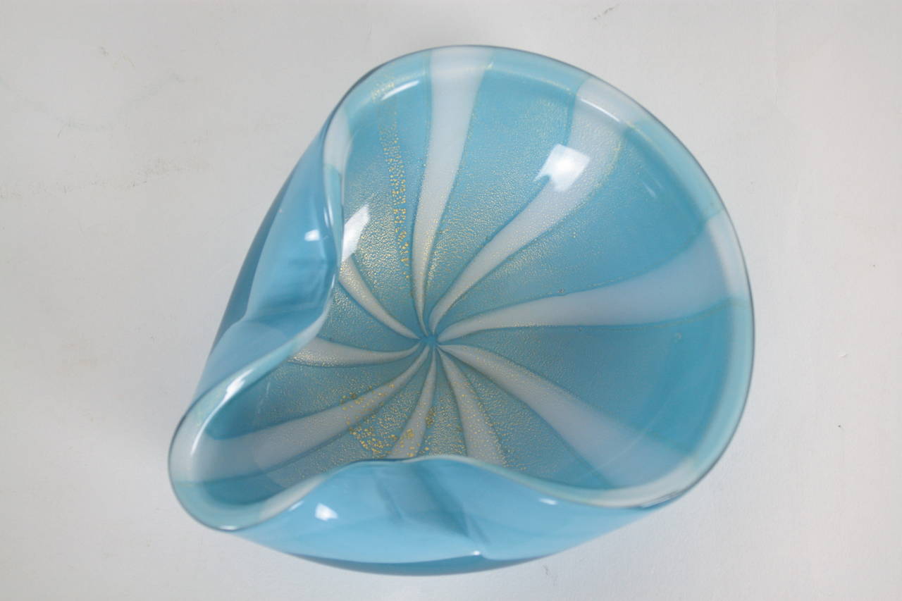 Impressive handblown Murano glass bowl with striped design in white and blue turquoise colors and gold flecks.

Avaliable some other Murano glass pieces shown on our storefront.