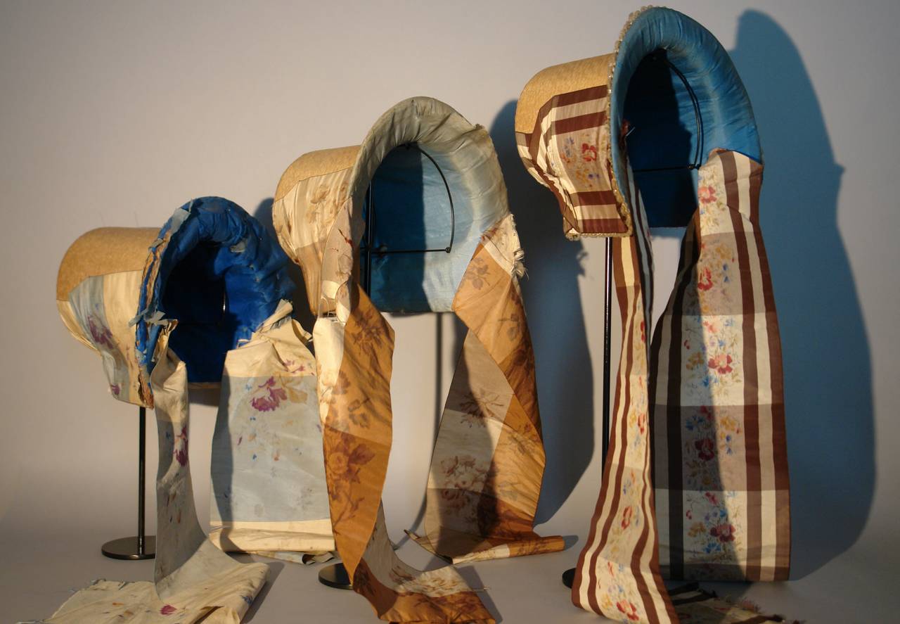 Ikat A group of three English Regency straw bonnets circa 1820