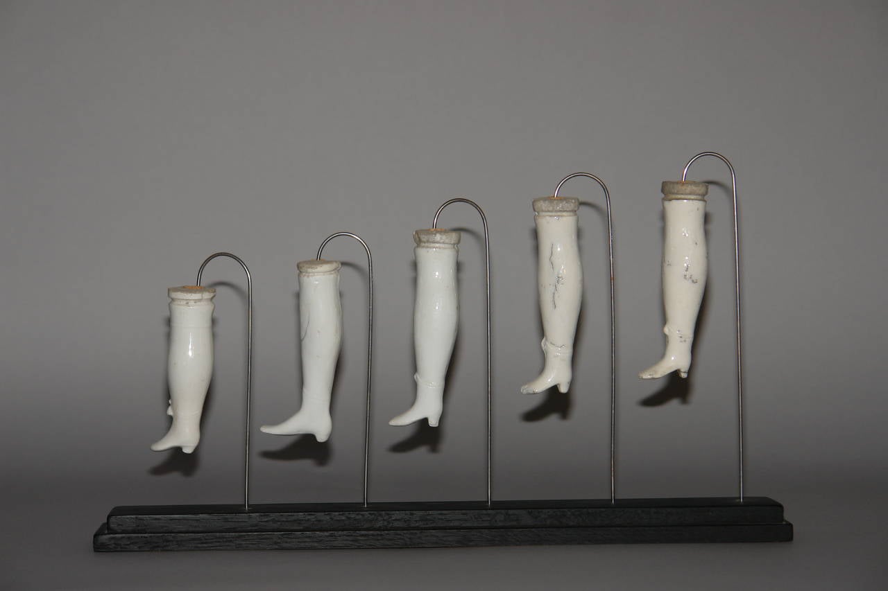 19th Century A collection of 19 French Porcelain Doll Legs mounted on 3 stands