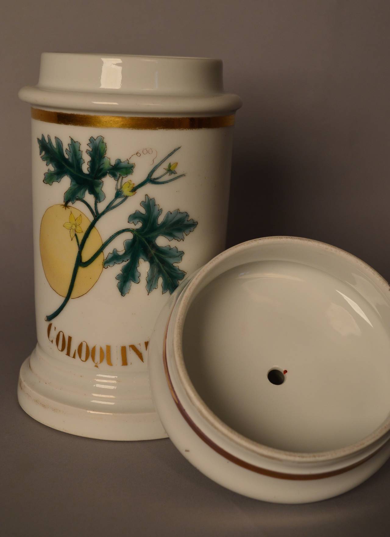French porcelain apothecary jar with gilt trim and letters, circa 1850.
Beautifully hand-painted depiction of the coloquint fruit on the vine.