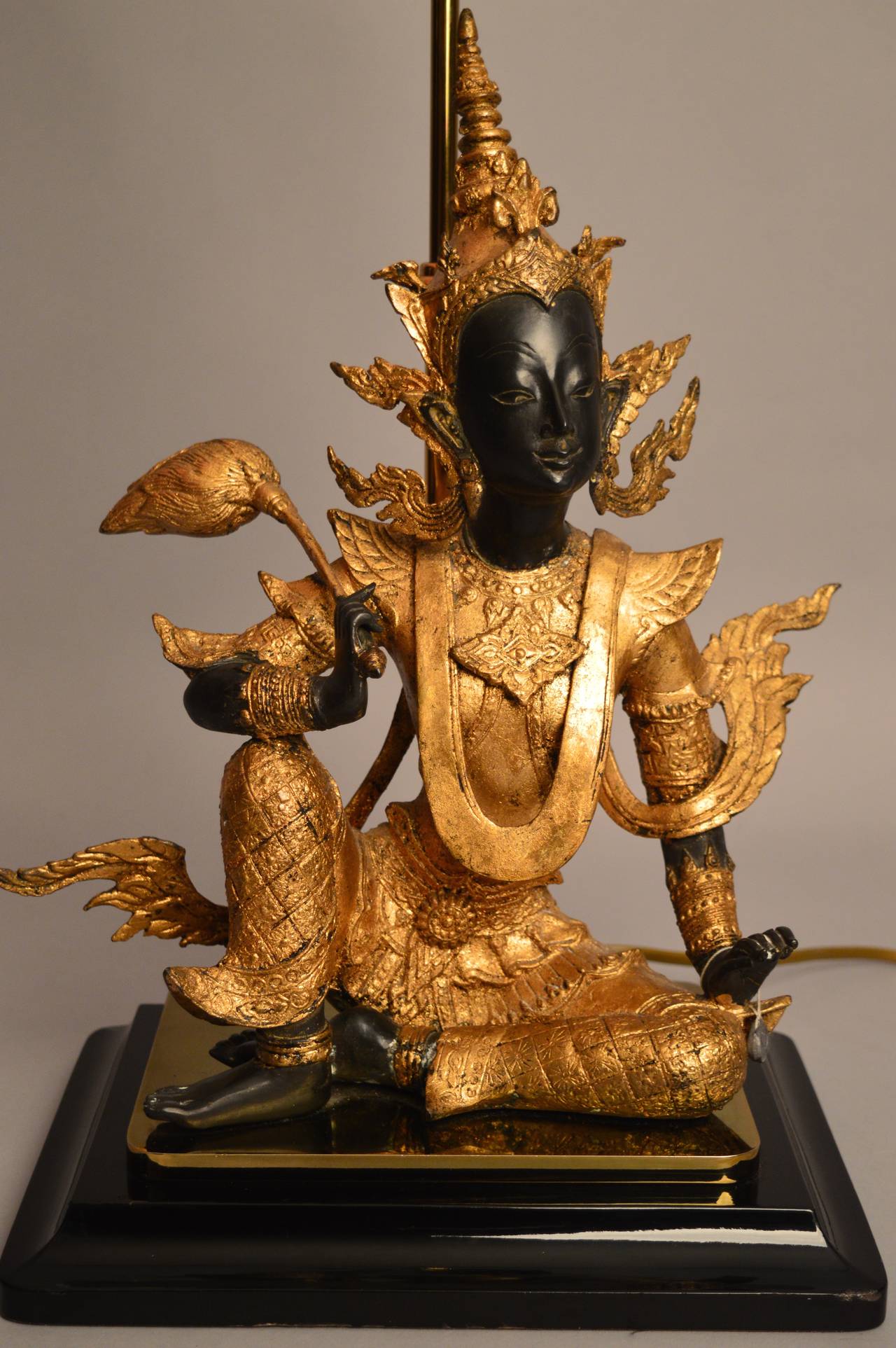 A very fine 20th century bronze statue with hand applied gold leaf of the ancient Cambodian dancing goddess Apsara. The bronze has been mounted on a statue base lamp Stand in the 1960s where it was used in the Parisian apartment of a set