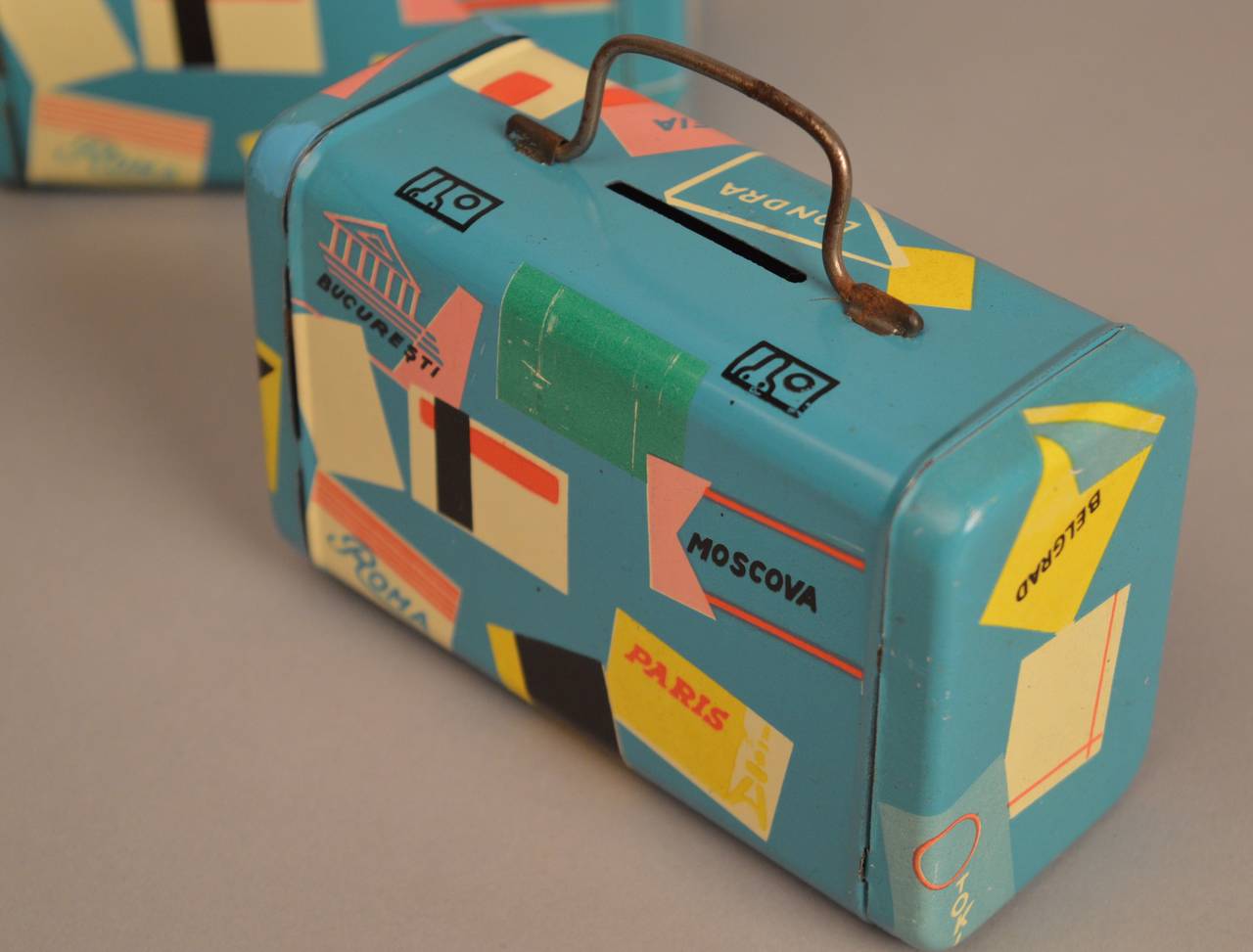 A wonderful find of ten unused 1960s tin banks in the form of chic well traveled suitcases. 
These banks came from the old stock of a 1960s toy store in the center of Antwerp Belgium.The condition is good except from some small chips and