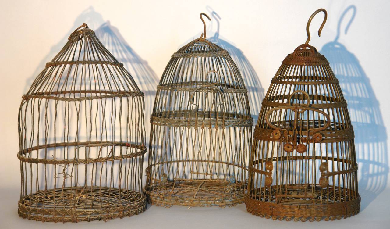 A group of Three Tunisian wirework bird cages . Each cage is unique , one with traces of the original turquoise blue paint.
largest=10.25 w x 17