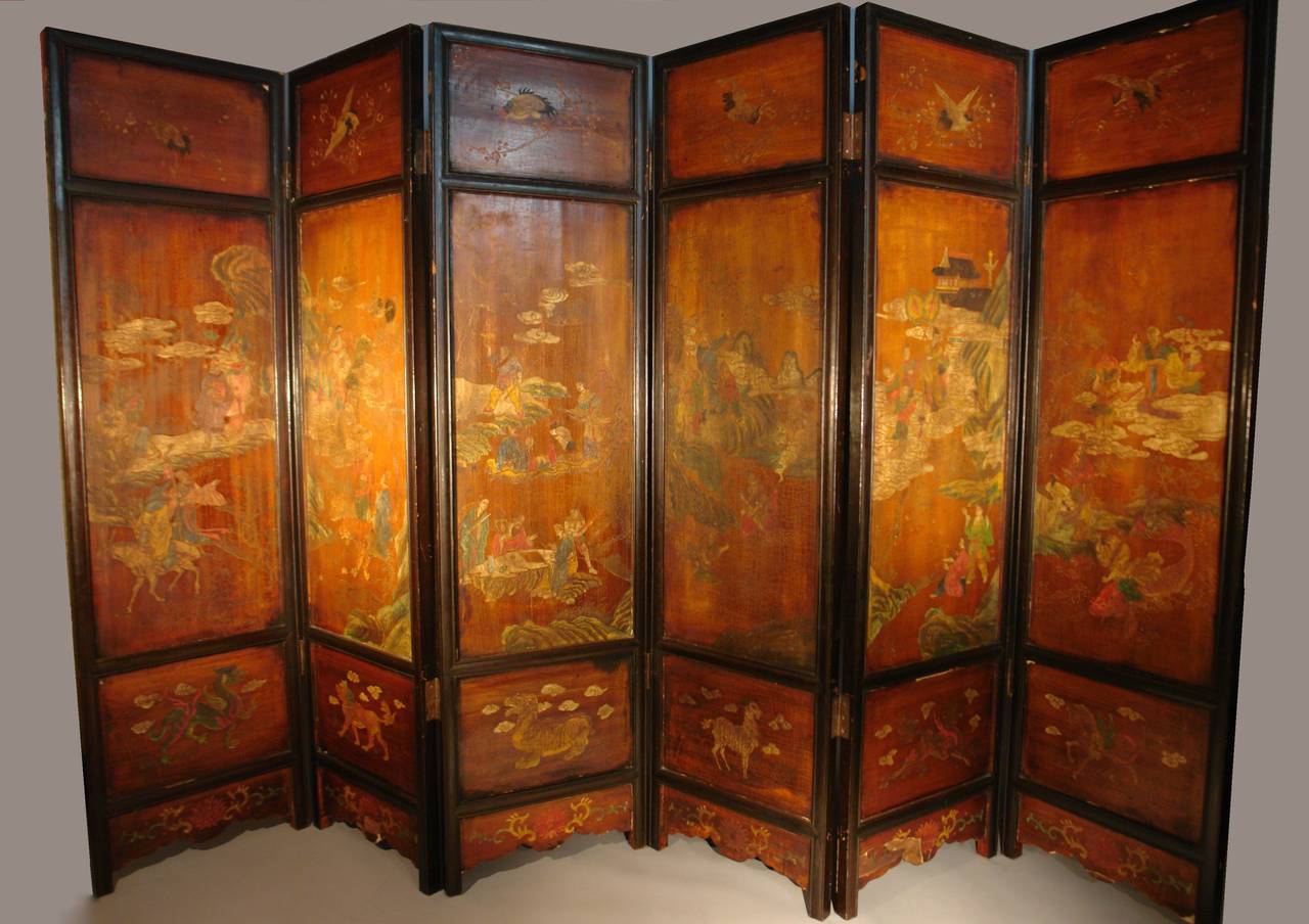 A fine 19th century Chinese Qing dynasty six panel coromandel folding screen.
Carved coromondel decoration on both sides in a beautiful tea color with a rich overall patina. This screen was originally made to divide a room so there is no front or