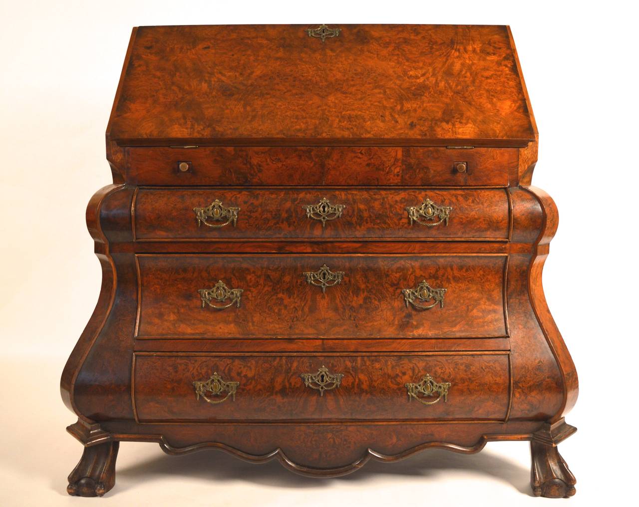 Dutch Rococo style bombe form burled and oyster walnut secretary.
The interior contains curved drawers and a center door flanked by two secret pull-out faux leather book compartments. To the rear of the writing surface another sliding door reveals