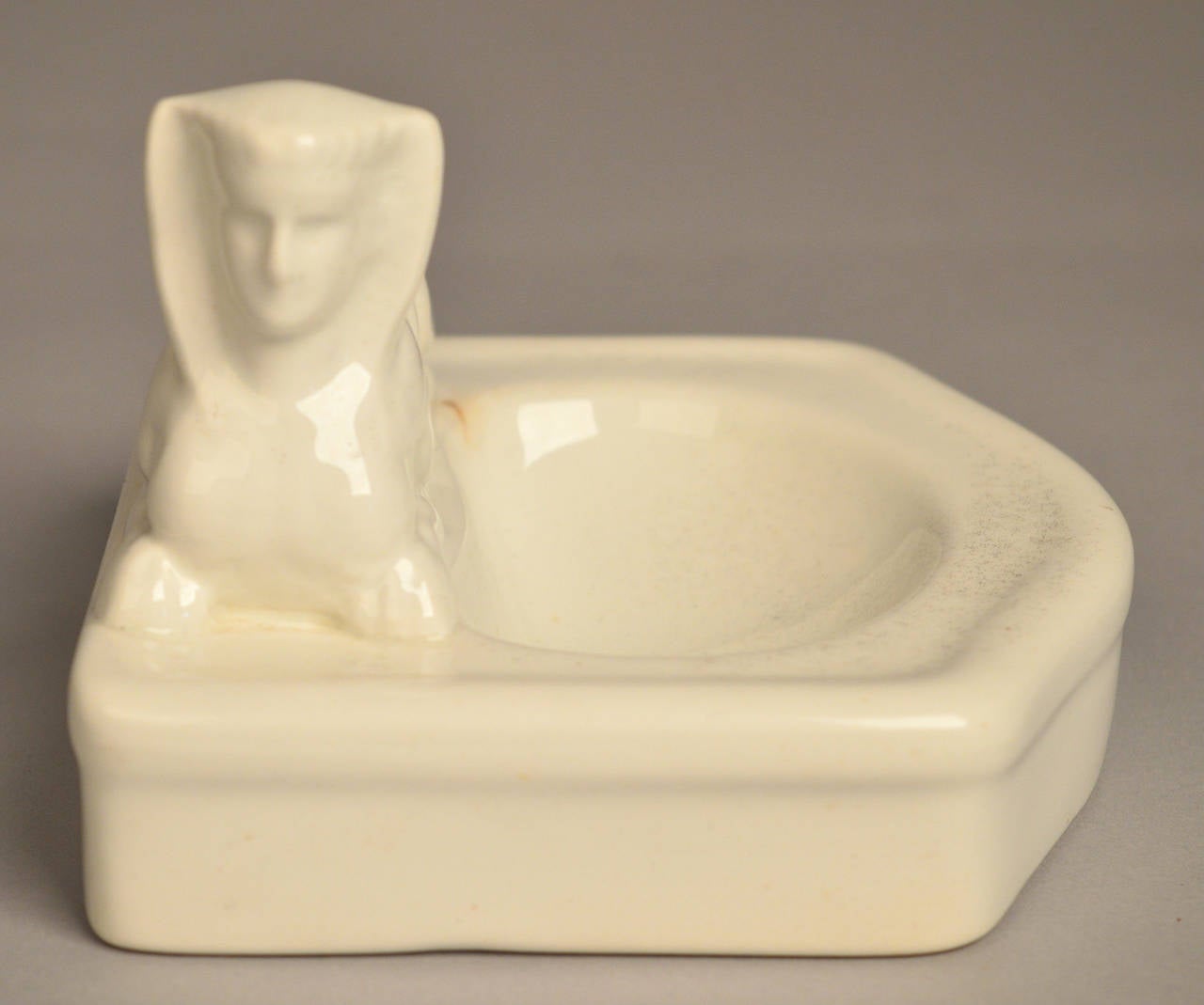 A Belgian white glazed ceramic (ironstone) soap dish circa 1880.
This egyptian revival sphinx design is rare so the fact that it has a chip at the underside of the base is acceptable.
***The chip is not visable unless turned upside down(as shown