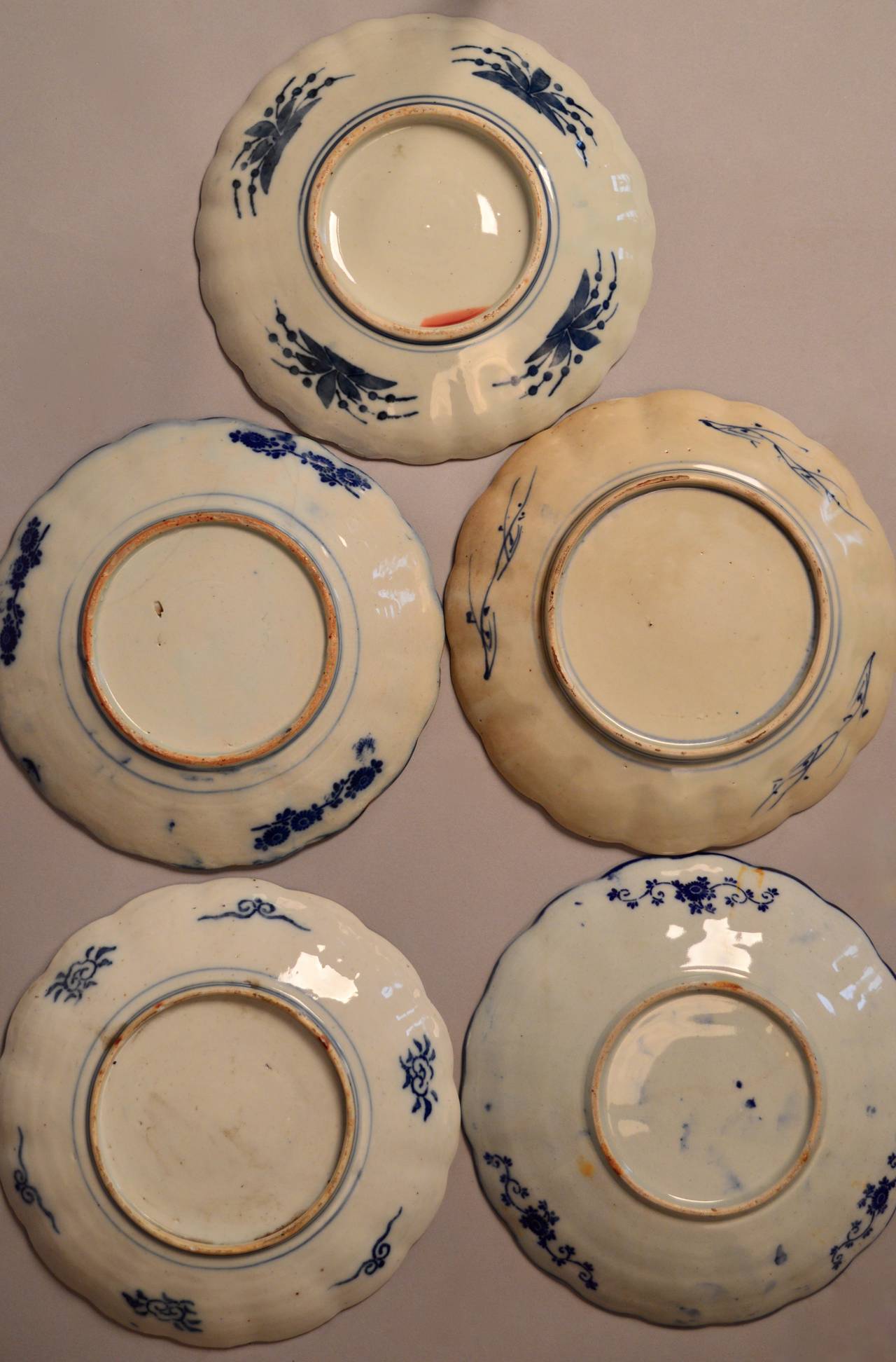 A collection of five 19th century Imari scalloped edge plates from the Meiji period. Central urn design with field glazed in the traditional orange, blue green and white.
