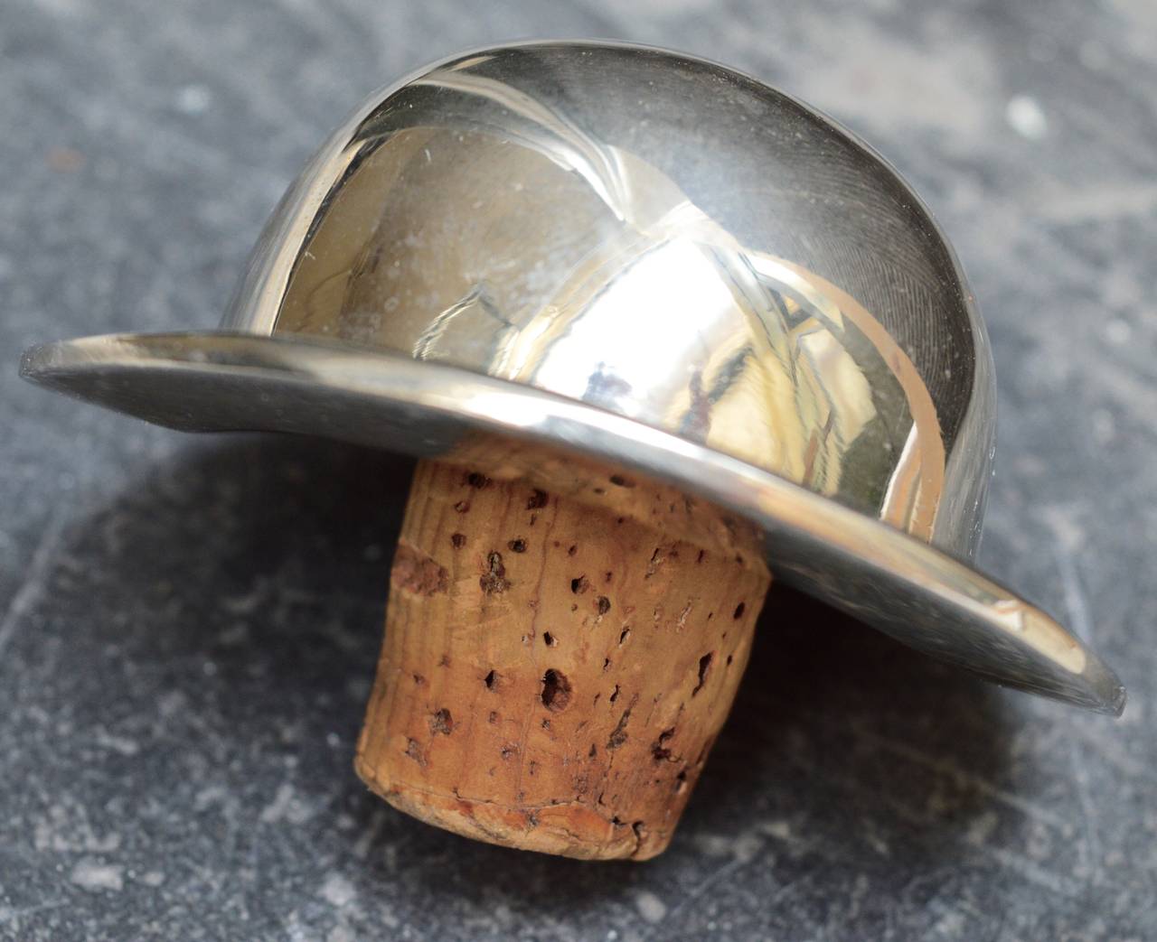 A most unusual and chic bottle stopper in the form of a bowler hat (makes me think of John Steed, or odd job from gold finger)
 Heavy silver plating in excellent condition.