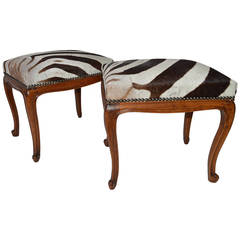A pair of French Louis XV style benches with zebra upholstery