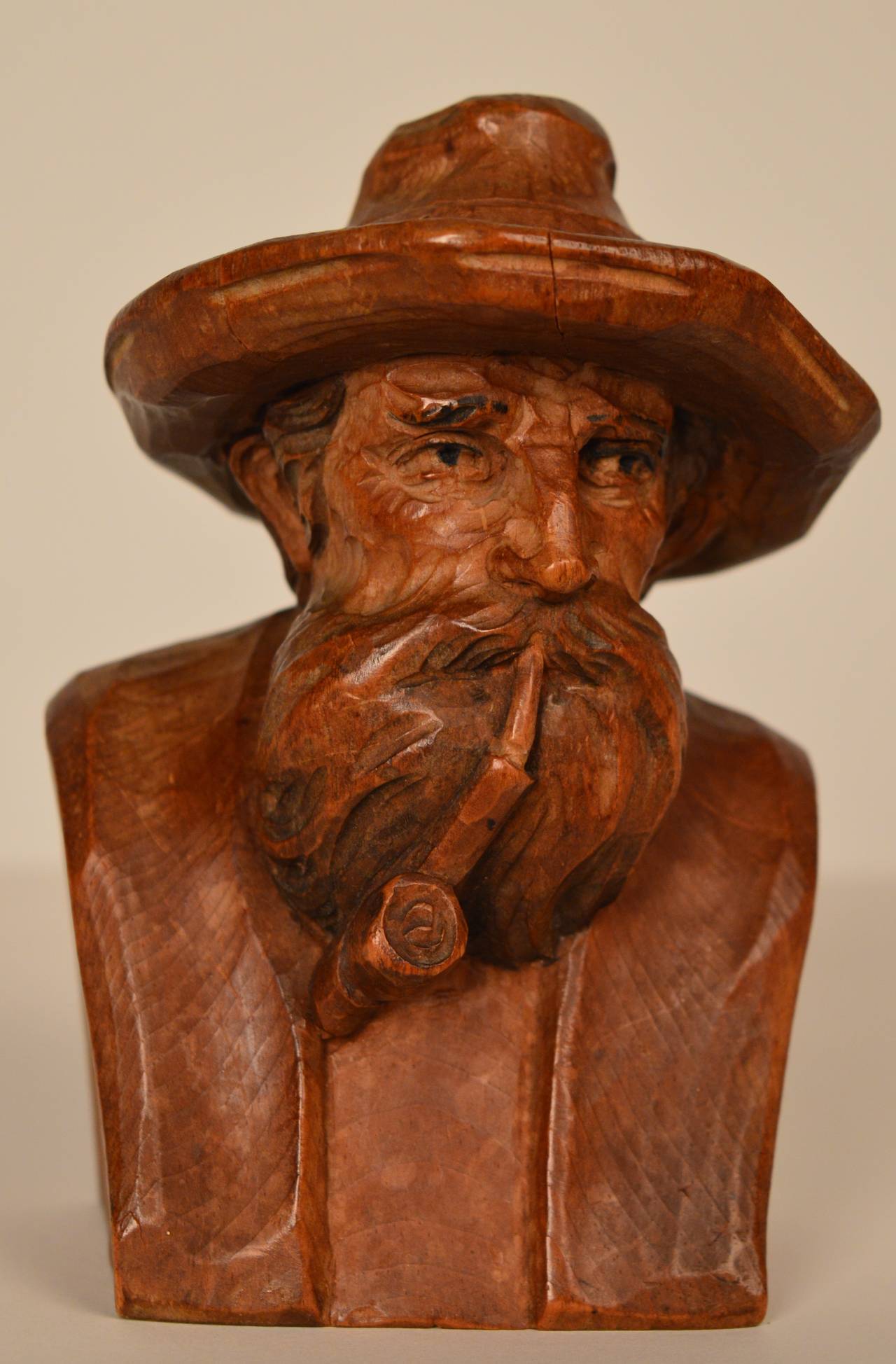 A carved wood (pine) bust of a old man.
The skill of the sculpter projects the wisdom and peace of this elderly man. Excellent condition and a warm carmel patina add to the feeling the carving projects. 
Purchased from a Belgian estate and
