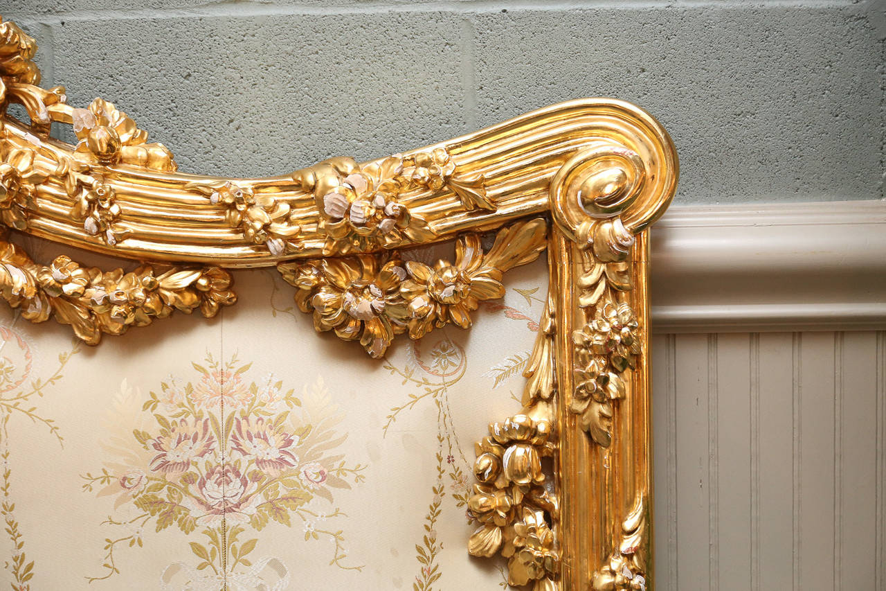 Heavily carved king headboard purchased in 1999 and gilt in 22-carat gold.