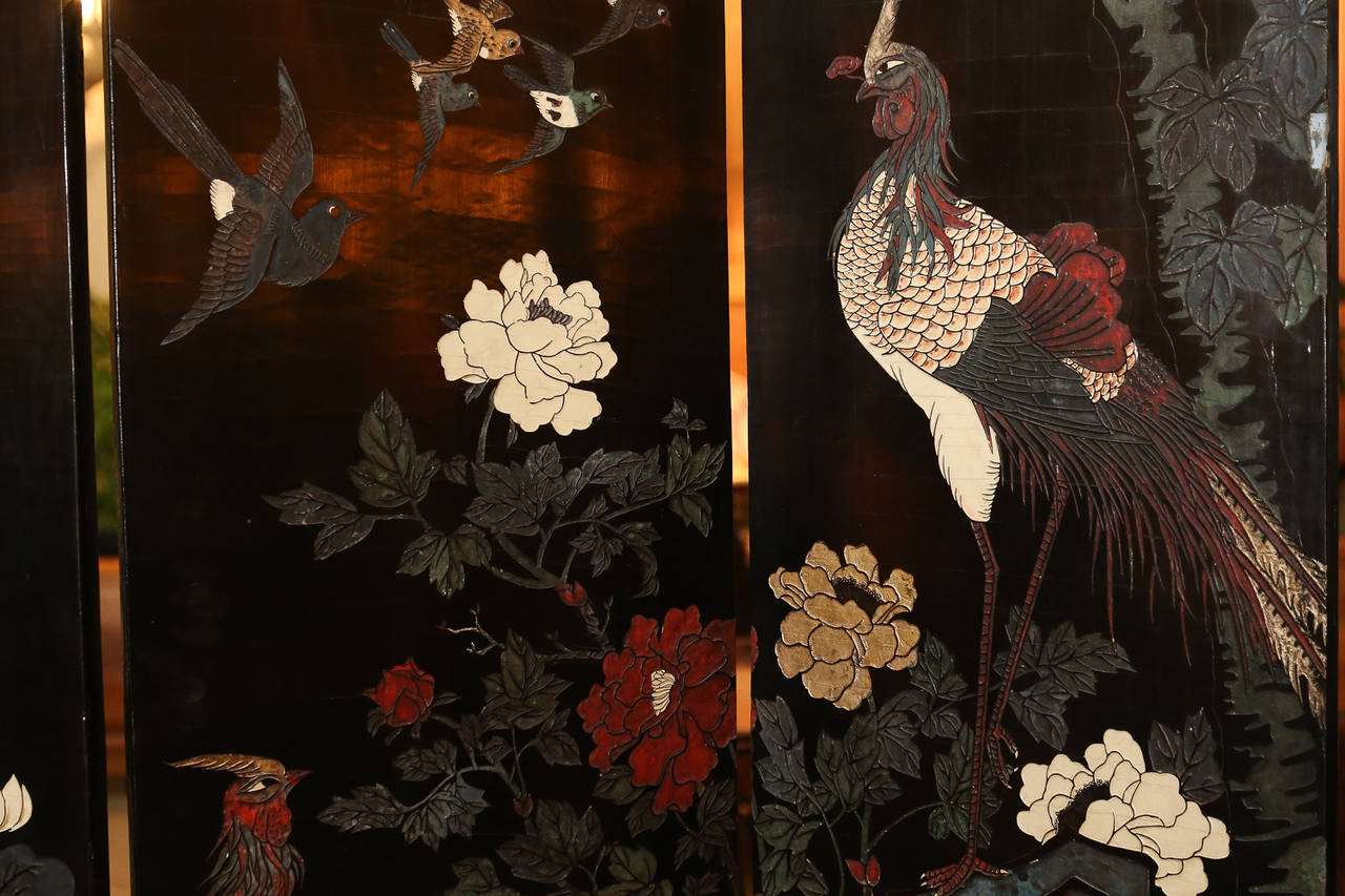 Five panel Black Lacquer Screen with both sides painted with birds and flowers.

One side is more decorative with color, the other a simpler design featuring
monochromatic background of tree branches featuring white flowers and white
breasts of