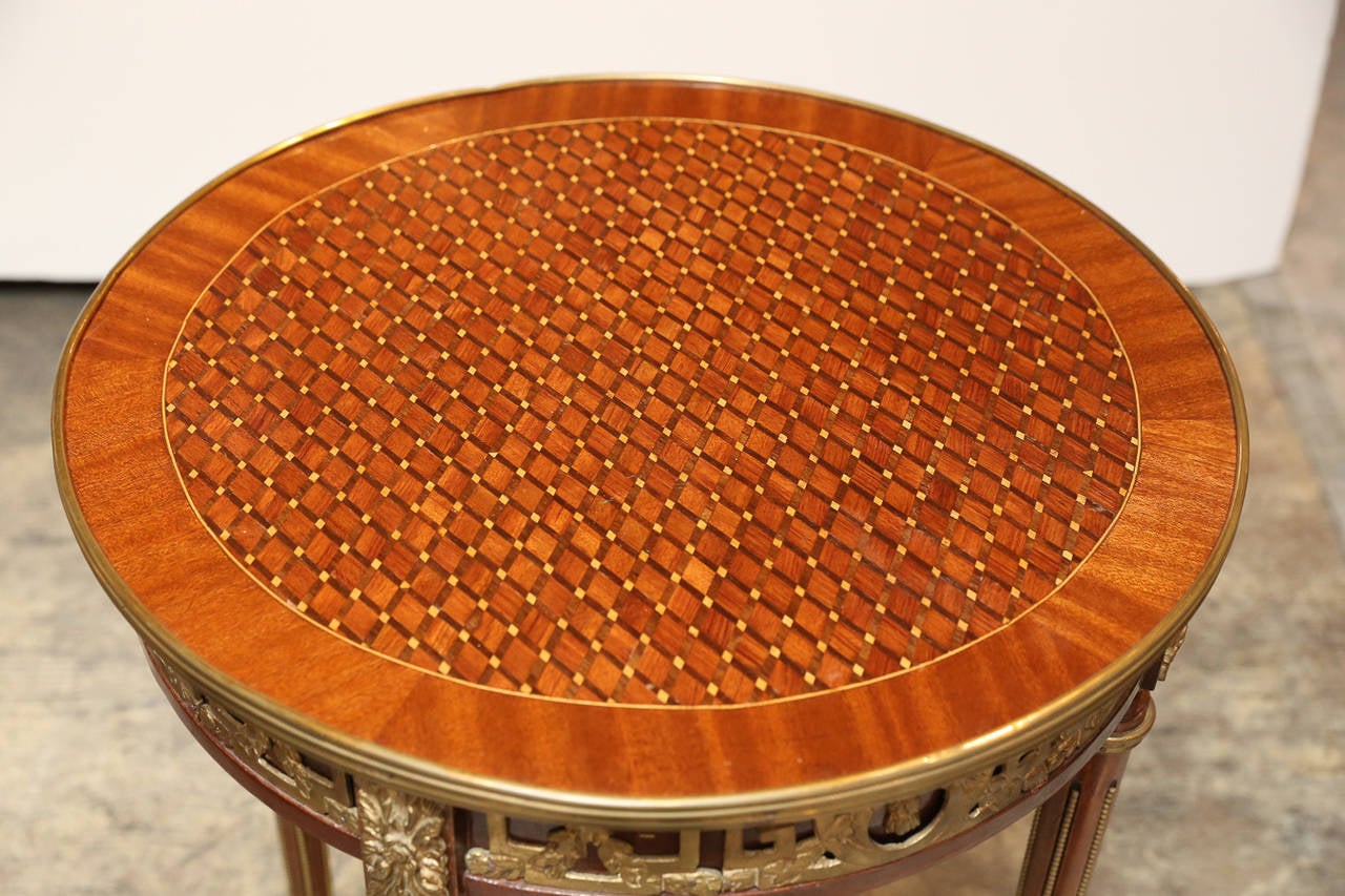 Top has beautiful marquetry pattern. Rosettes are Gilt Bronze along with all other details

Tapered legs are fluted with Brass Beading and gallery has fluteded brass banding