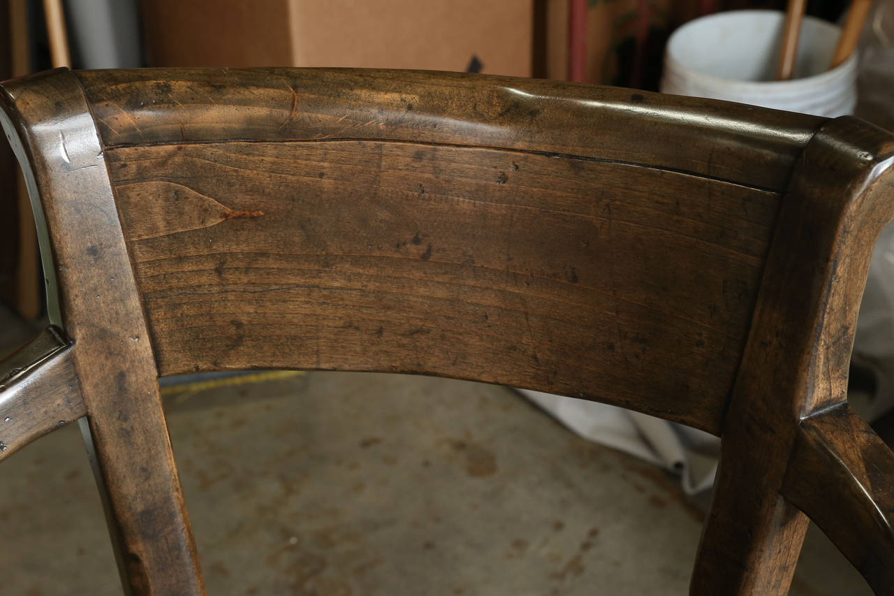 English Sabre-Leg Swivel Barstool manufactured by Sterling Collection.

Finish is Standard Antique English

Features nailhead around upholstered seat