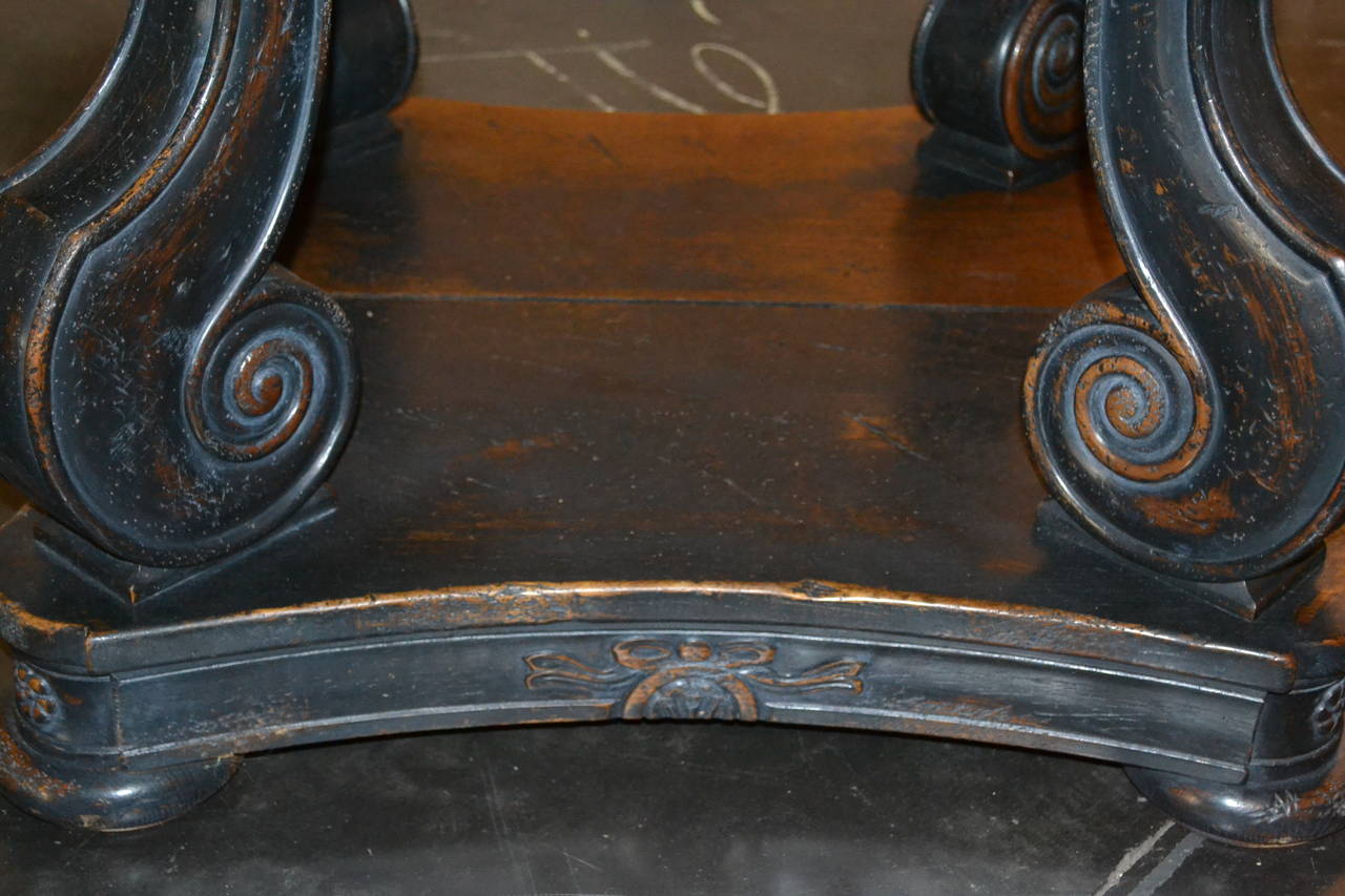 This unique Italian table has an oak top and painted black base, that sits on four scrolled legs, with edge detail, that rest upon bun feet.
The top opens and has two 20