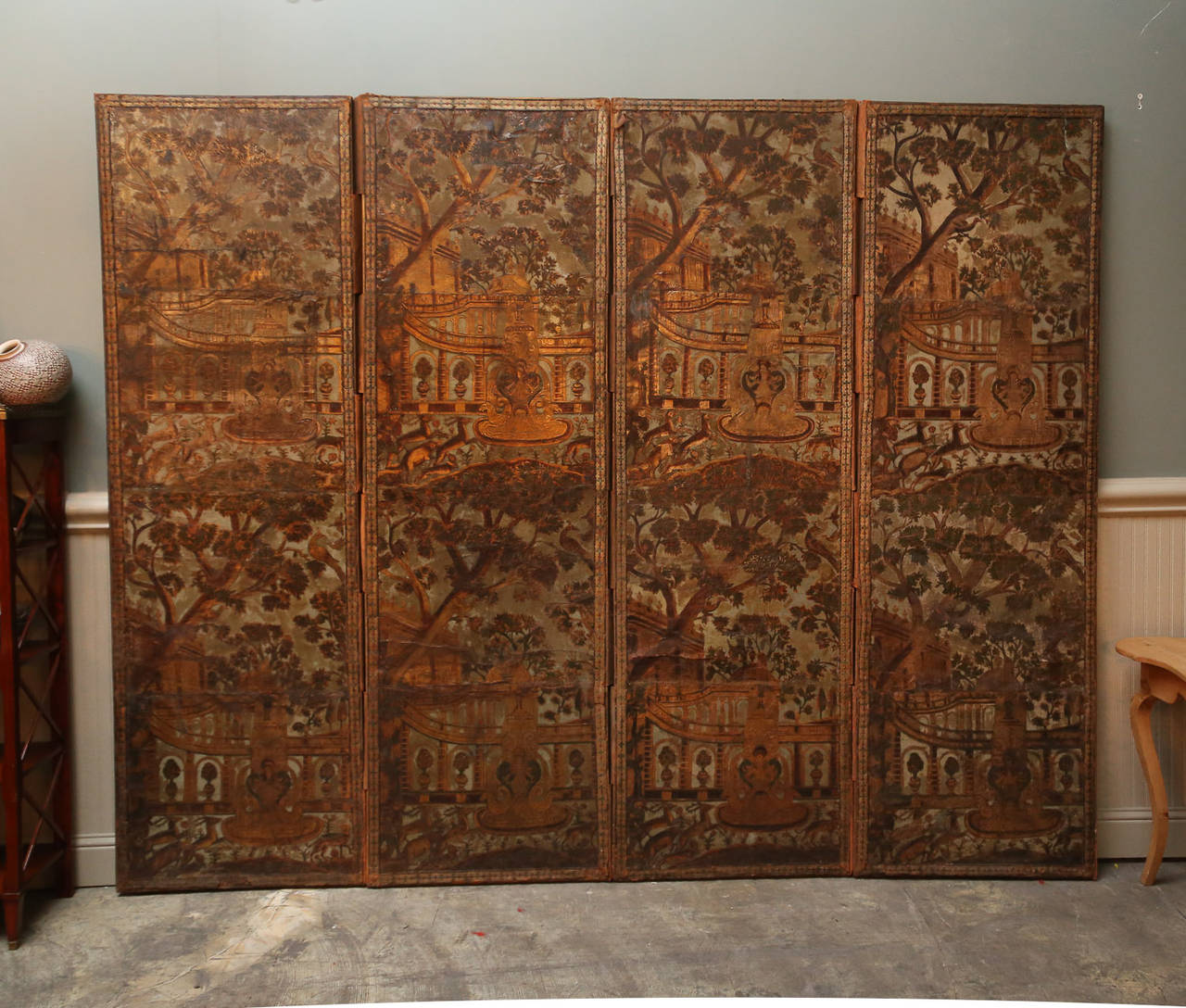Four-panel embossed screen with Moorish influenced floral and fauna depicted in repetitive design.

Colors are blues greens, and gold colors.

Quite unusual and very handsome.