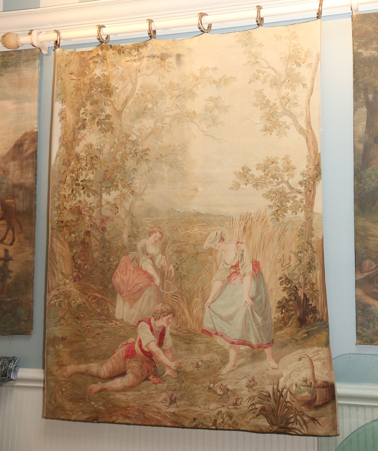 Muted color Aubusson tapestry depicting a pastoral scene with figures gathering from
nature. Soft peaches, blues and neutrals are ideal for today's interiors.