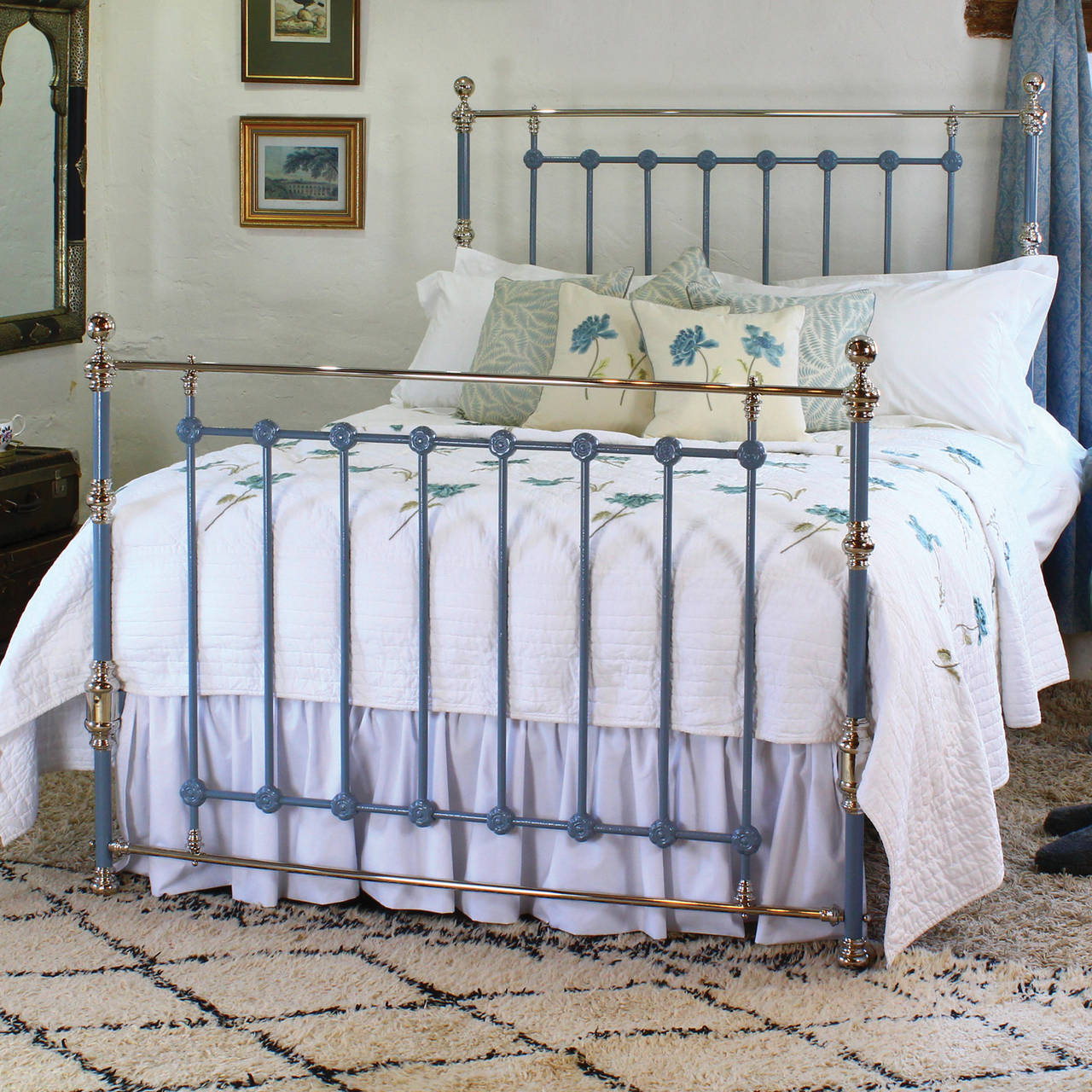 A king-size brass and iron bedstead finished in ‘battleship grey’ with nickel-plated brass work.
This bed is a breakdown frame in that the panel dismantles from the outer posts releasing the cross irons so that it will go up any awkward staircase