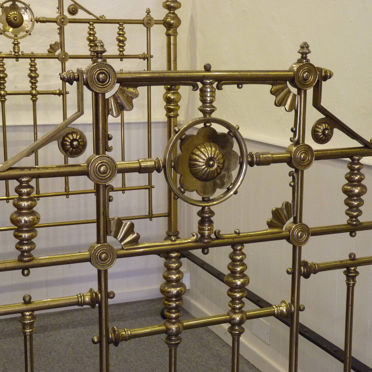 An original late-Victorian brass bedstead in superb condition manufactured by Maples. The decorative fittings are all cast brass, creating a substantial, heavy and totally original brass bed. 

This bed will accept a British king-size or American