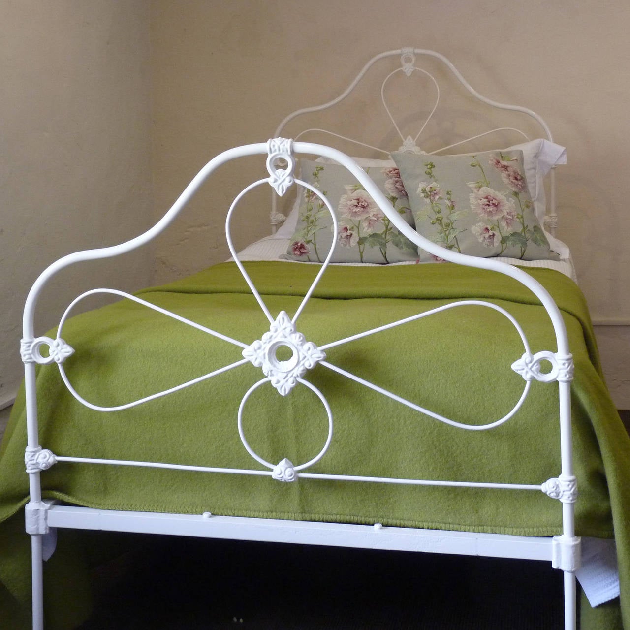 Pretty Mid-Victorian cast iron bed, powder-coated white with dainty decoration.

This mattress for this bed is a large single, 3 ft 6 in wide by 6 ft 3 in long.

The price is for the bed frame alone. The base, mattress, bedding and linen are extra.