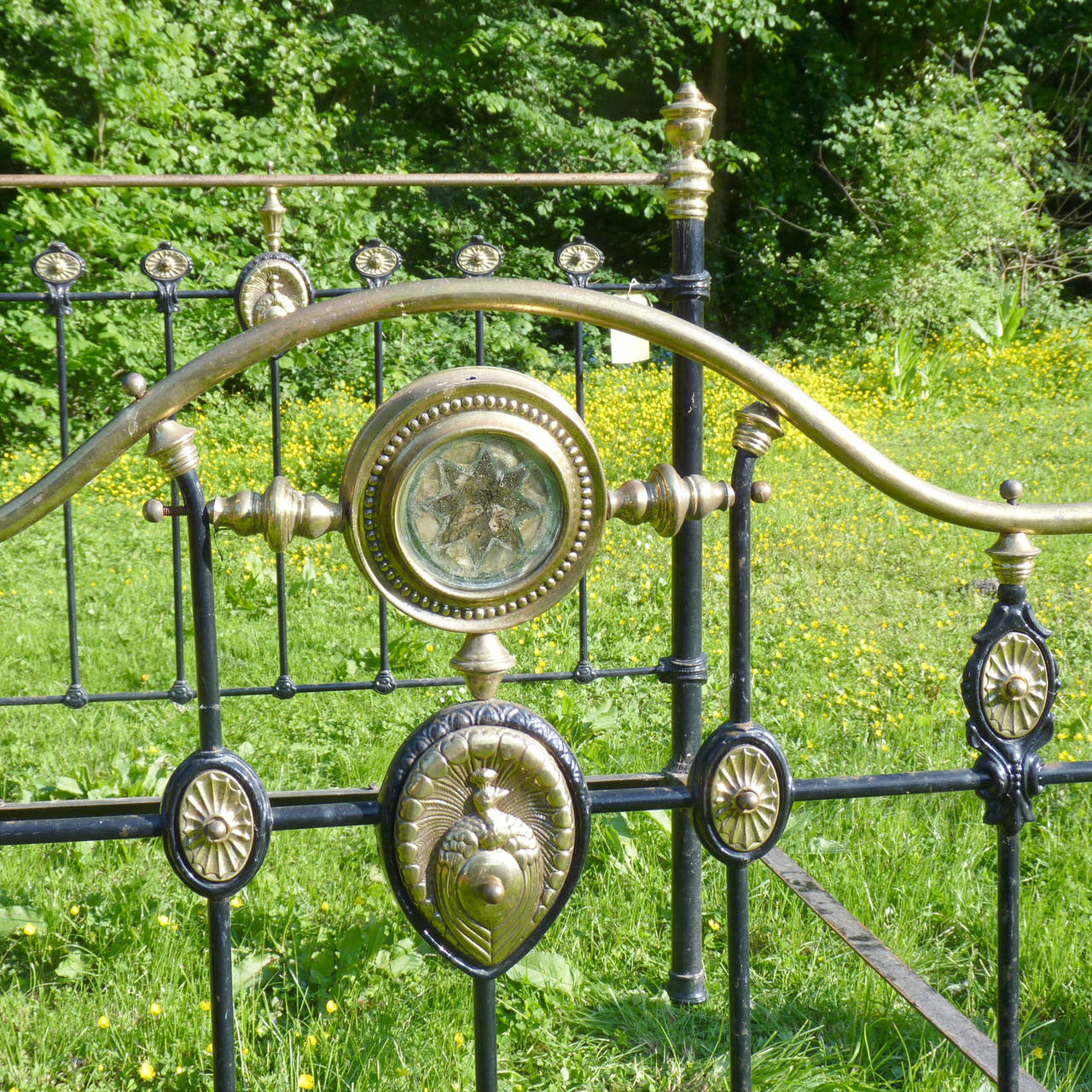 A fine original decorative bedstead with elaborate brass ornamentation including central “peacock” rosettes. This bed was originally made in the Birmingham area of the UK around the end of the Victorian era.

There are three options for this