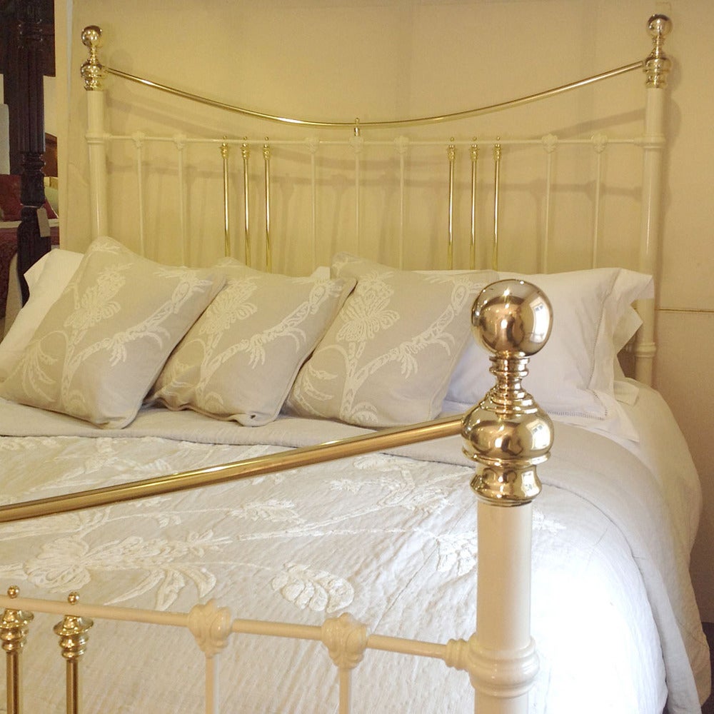 A fine Victorian bed extended out to the 6 ft width (72 in) finished in cream with a curved brass top rail.

This bed accepts a 6 ft wide (72 in. or 180 cm) mattress, which is a British Super king-size or Californian King. The length of the