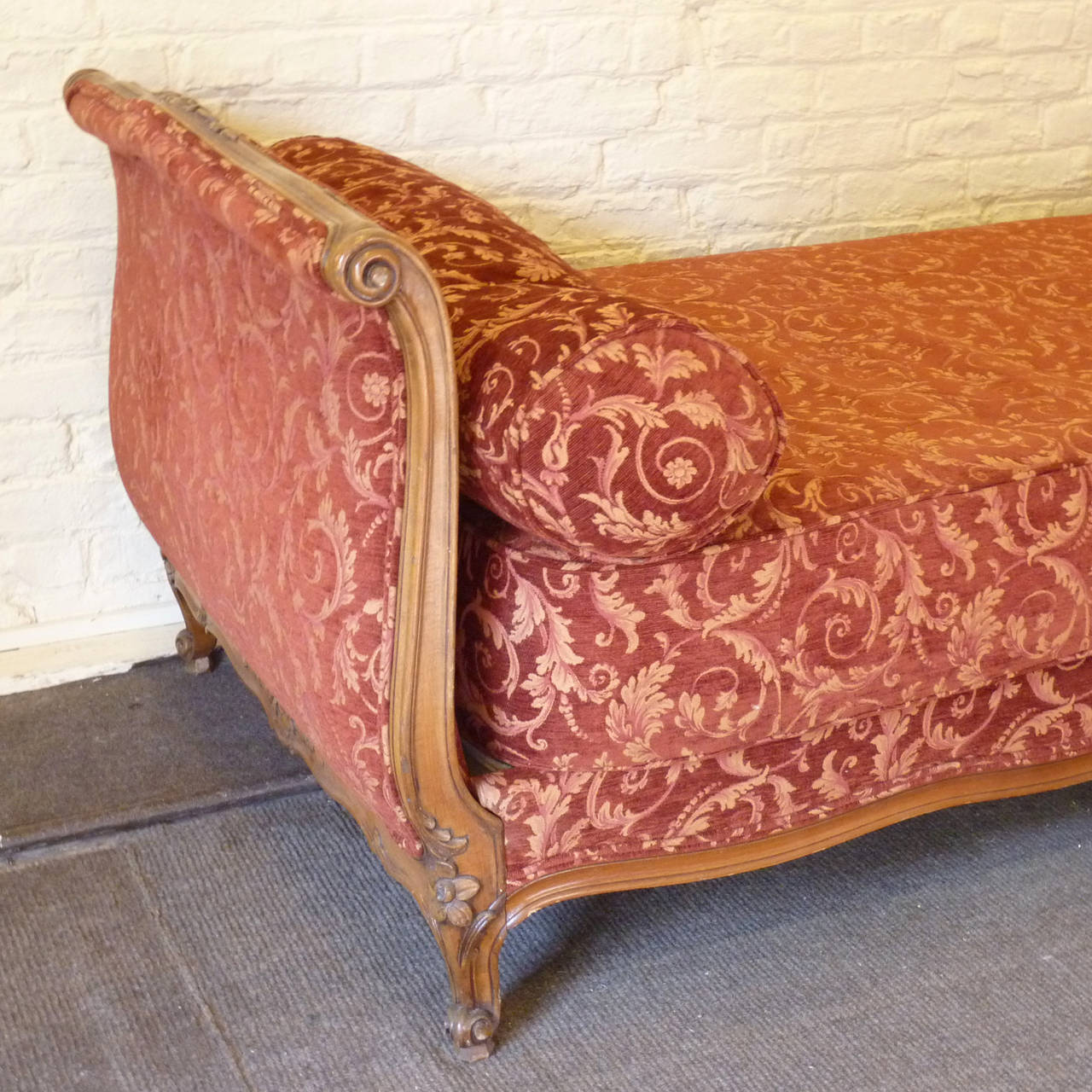 A French Louis XV style roll-ended day bed upholstered in a raspberry scroll chenille fabric.

The base, mattress and two tubular cushions are included in the price.

The dimensions of the bed are:
Absolute Width: 39 in (99 cm)
Absolute