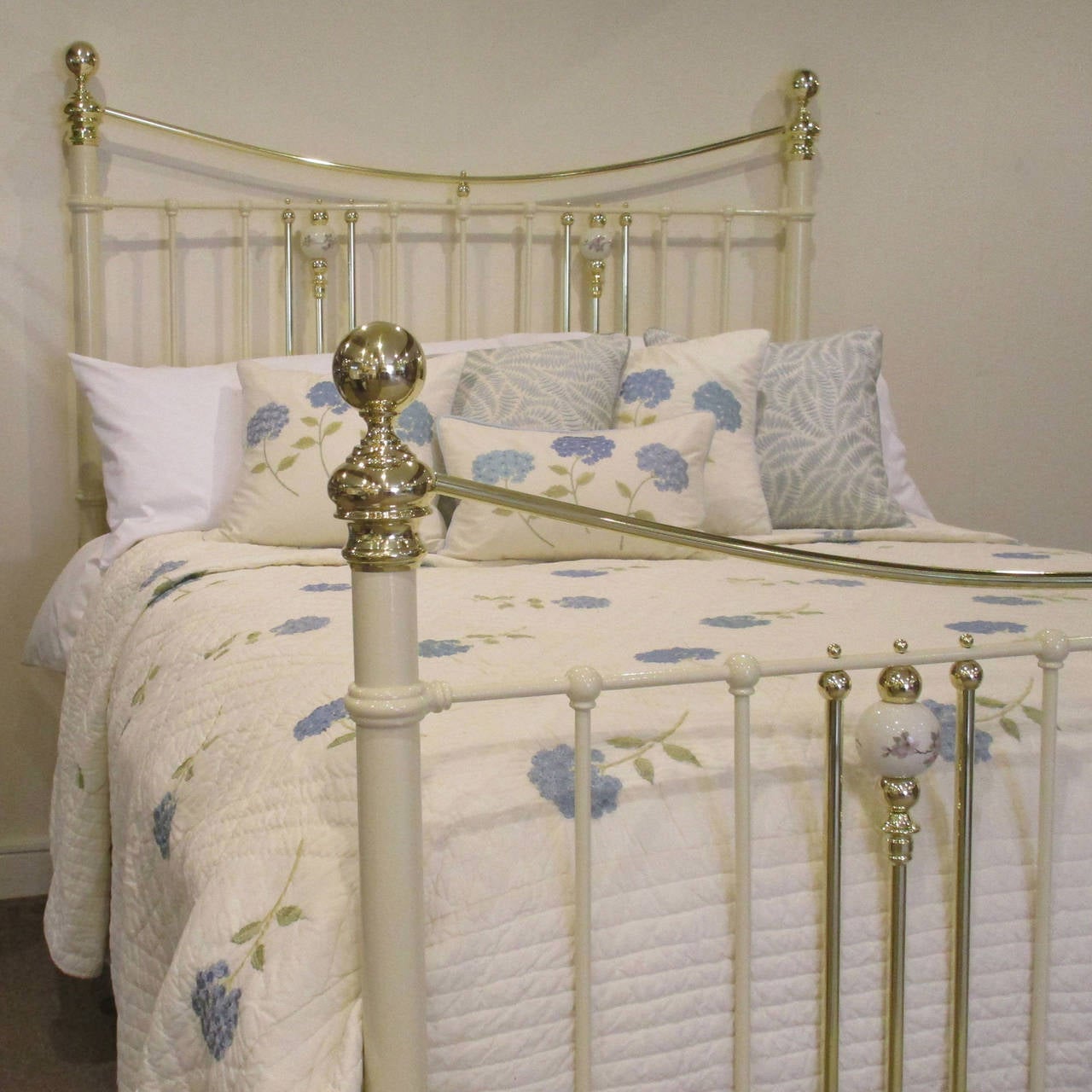 This fine bedstead, adapted from an original Victorian frame, has been finished in cream and has decorative china porcelain balls in the head and foot.

This bed is 60 inches wide and accepts a British king-size or American queen-size base and