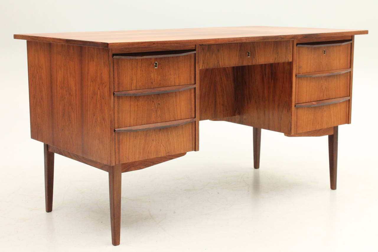 Beautiful rosewood desk that is finished on all sides. This item can sit in the middle of an office or study and no one can tell the back from the front! The grain in the wood of this desk is truly breathtaking - you do not want to miss out on this