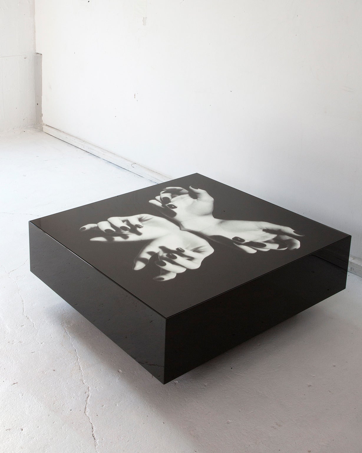 Cocktail table with black mirror top printed with an original digital collage by artist Gordon Magnin.

Shown in black.
Measures: 36