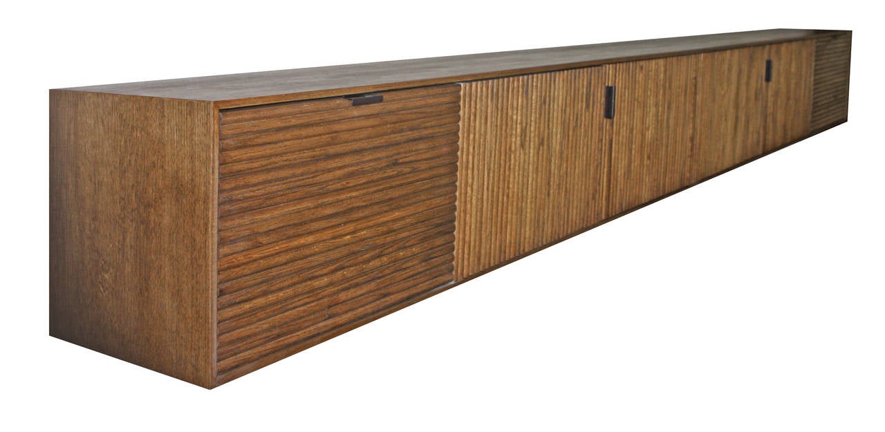 Tambour-clad wall-mounted buffet, credenza or console shown in oak with walnut stain.
Measures: 12' W x 16