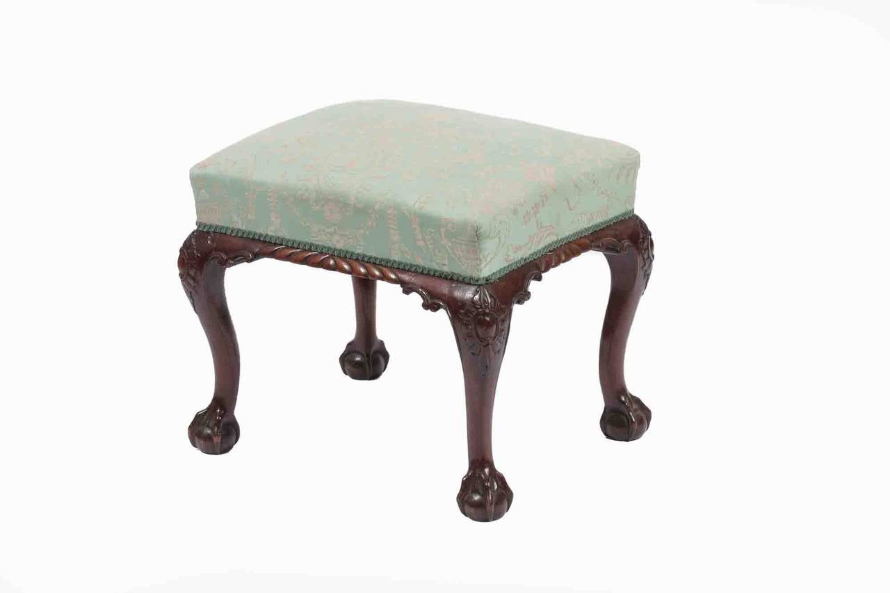 19th Century Mahogany stool with upholstered seat above gadrooned and scroll edged frieze, raised on cabriole legs. Terminating on ball and claw feet.