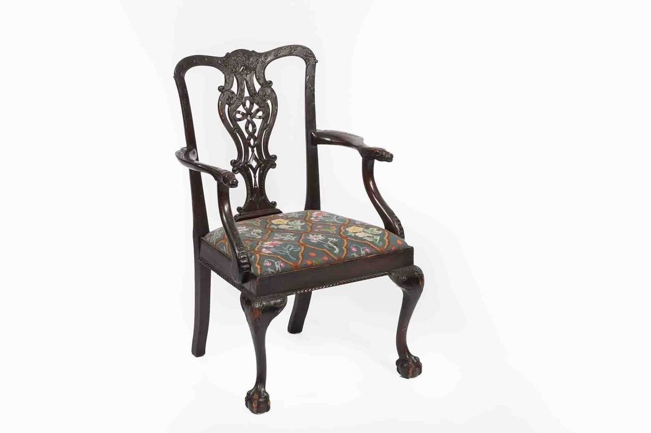 18th century Irish occasional chair in the manner of Thomas Chippendale, the bow shaped top rail with carved acanthus leaf and bell husk flanked with scrolling acanthus and C scrolls raised over pierced splat with finely carved ribbon motif, C and S